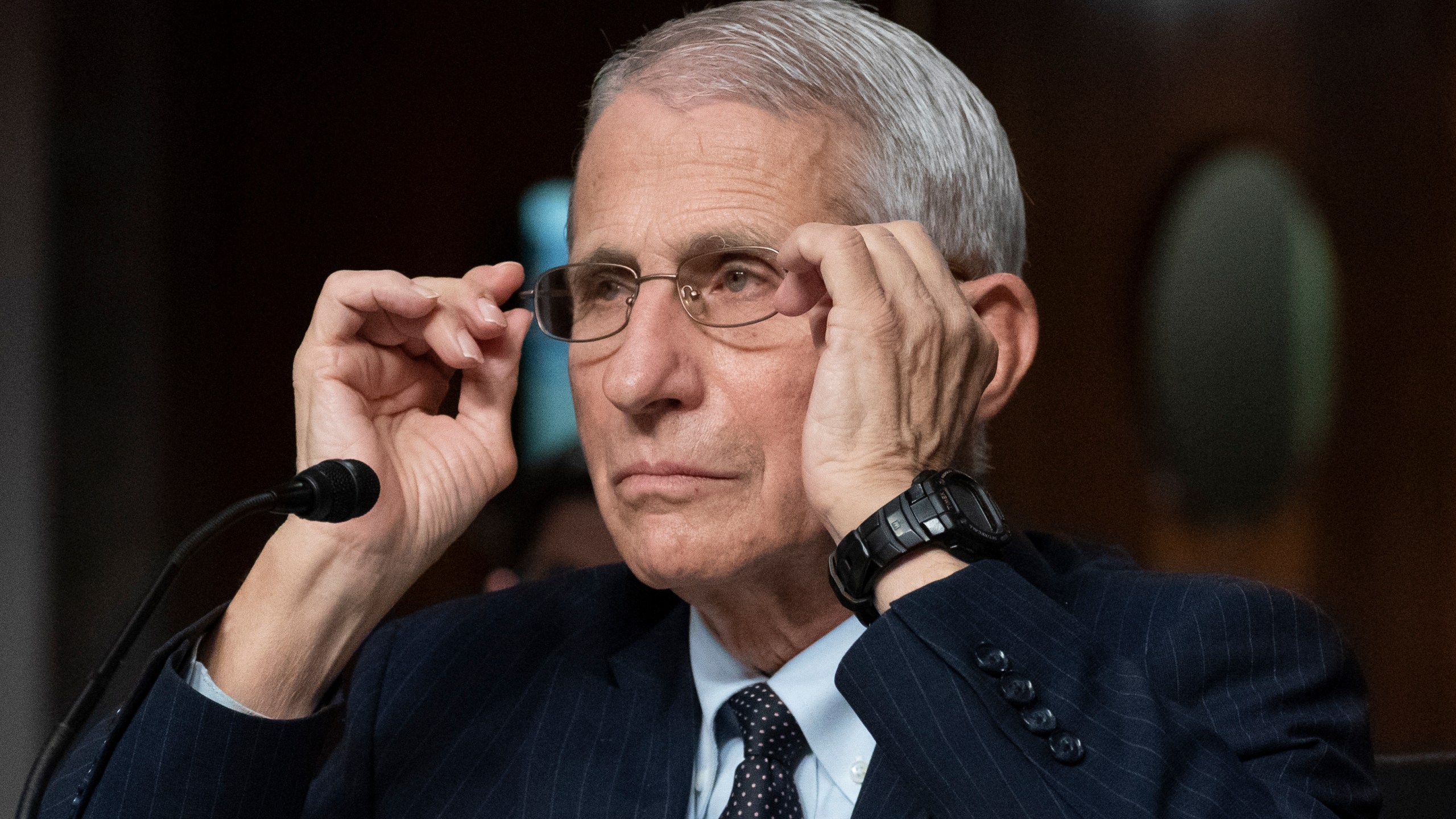 FILE - Dr. Anthony Fauci, director of the National Institute of Allergy and Infectious Diseases, adjusts his glasses during a Senate Health, Education, Labor, and Pensions Committee hearing on Capitol Hill, Nov. 4, 2021, in Washington. Fauci is expected to testify before Congress early next year as part of Republicans’ yearslong investigation into the origins of COVID-19 and the U.S. response to the disease. Fauci will sit for transcribed interviews in early January and a public hearing at a later date. (AP Photo/Alex Brandon, File)