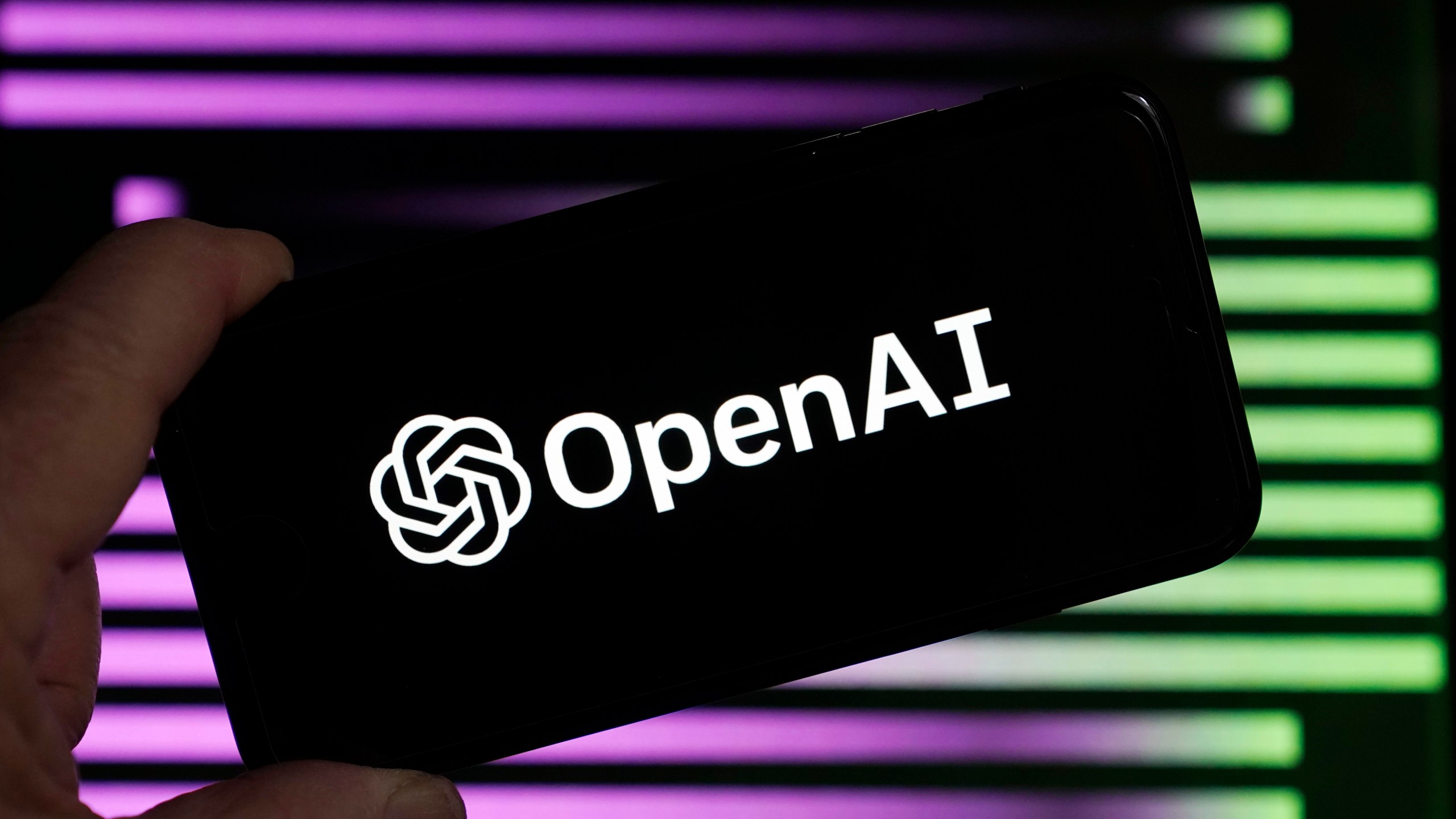 FILE - The logo for OpenAI, the maker of ChatGPT, appears on a mobile phone, in New York, Jan. 31, 2023. Lawmakers in Brazil’s southern city of Porto Alegre Brazil have enacted legislation written entirely by artificial intelligence. The experimental ordinance was passed in October and city councilman Ramiro Rosário revealed on Thursday, Nov. 29, 2023, that it was written by a chatbot, sparking objections and raising questions about the role of artificial intelligence in public policy. (AP Photo/Richard Drew, File)