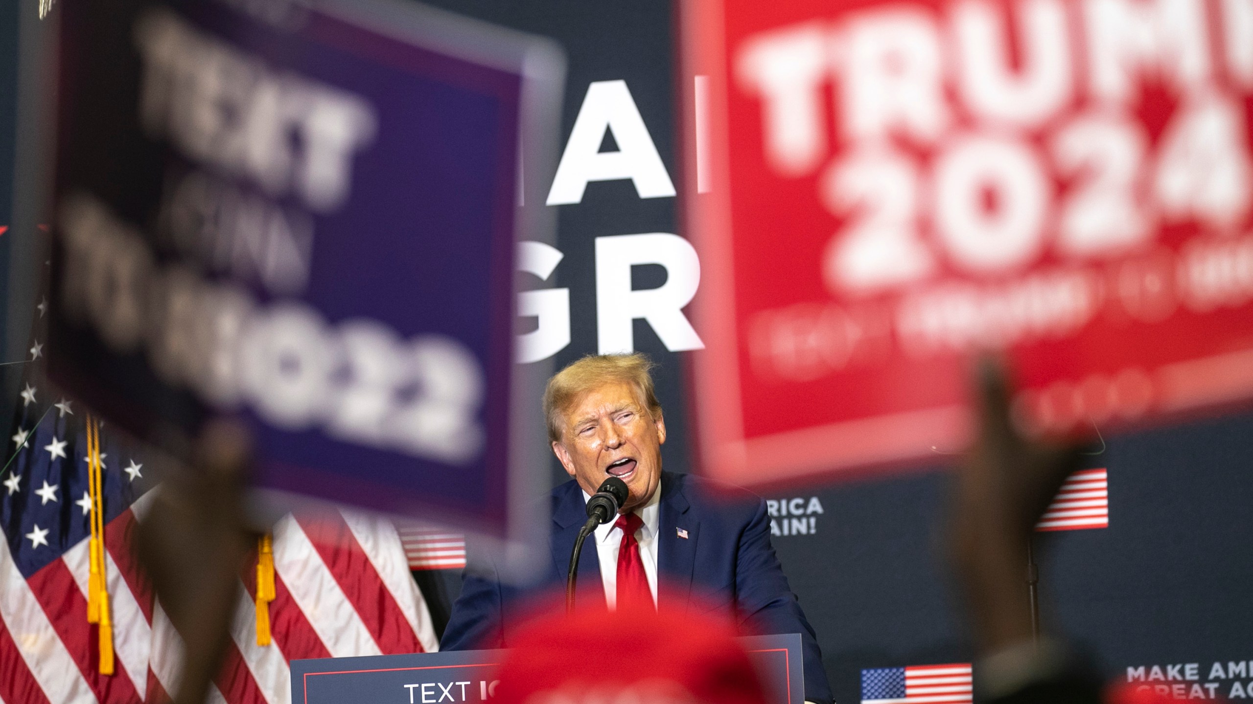 Republican presidential candidate and former President Donald Trump speaks to the crowd during a caucus event, Saturday, Dec. 2, 2023, at Kirkwood Community College in Cedar Rapids, Iowa. (Geoff Stellfox/The Gazette via AP)