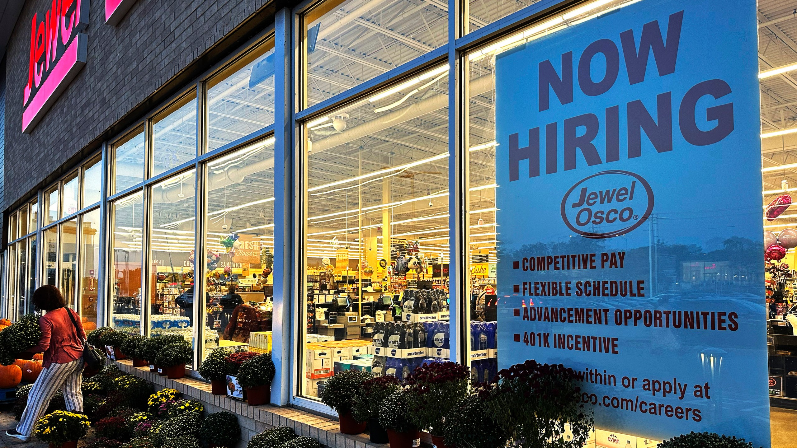 FILE - A hiring sign is displayed at a grocery store, Oct. 5, 2023, in Deerfield, Ill. Most business economists think the U.S. economy could avoid a recession in 2024, even if the job market ends up weakening under the weight of high interest rates, according to a survey released Monday, Dec. 4. (AP Photo/Nam Y. Huh, File)