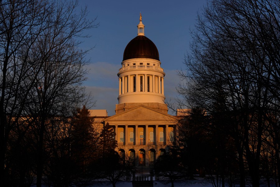 FILE - The Maine State House is seen at sunrise, March 16, 2023, in Augusta, Maine. Teachers and science advocates are voicing skepticism about a Maine proposal to update science education standards to incorporate teaching about genocide, eugenics and the Holocaust because of concerns about adequate teacher training and the nuanced nature of the material. The Maine Department of Education is performing the update as part of a review of standards that is required every five years. The proposed updates would have to ultimately be approved by a committee of the Maine Legislature. (AP Photo/Robert F. Bukaty, File)