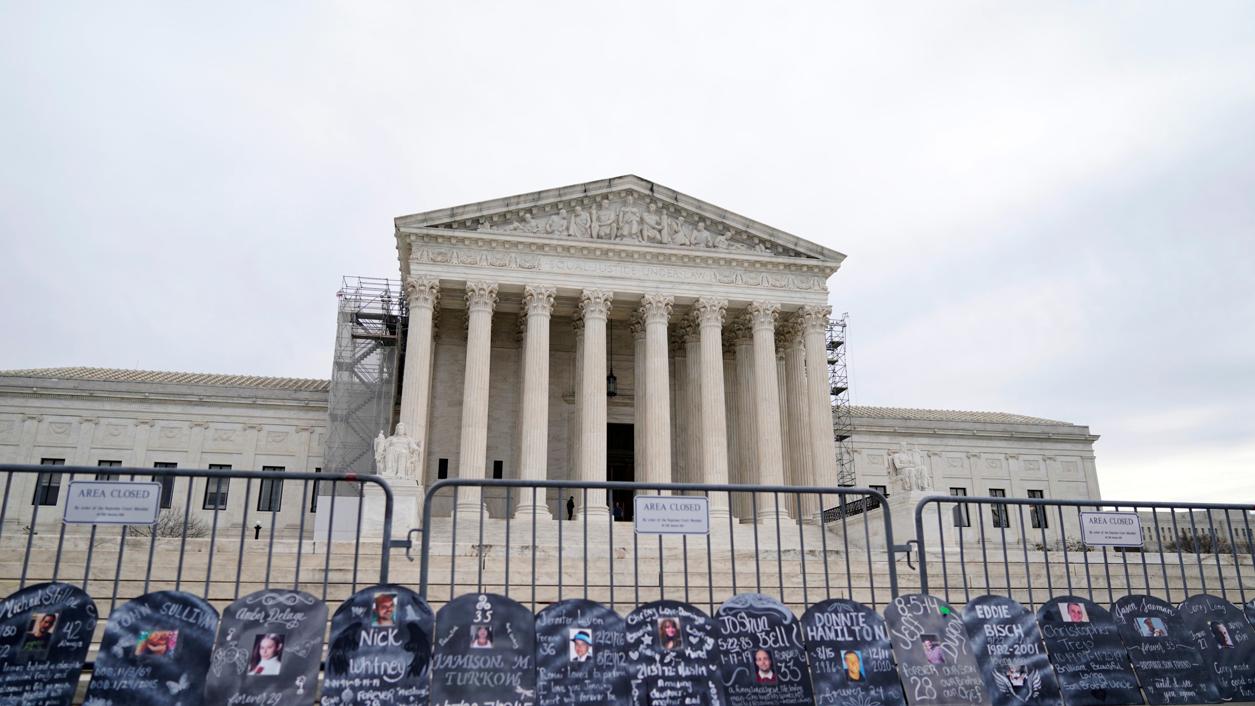 Signs in the shape of grave headstones, with information on people who died from using OxyContin, line a security fence outside the Supreme Court Monday, Dec. 4, 2023, in Washington.The Supreme Court is wrestling with a nationwide settlement with OxyContin maker Purdue Pharma that would shield members of the Sackler family who own the company from civil lawsuits over the toll of opioids. (AP Photo/Stephanie Scarbrough)