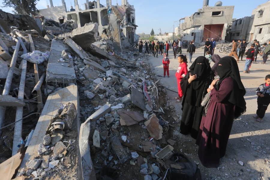 Palestinians look at the destruction by the Israeli bombardment of the Gaza Strip in Rafah, Monday, Dec. 4, 2023. (AP Photo/Hatem Ali)