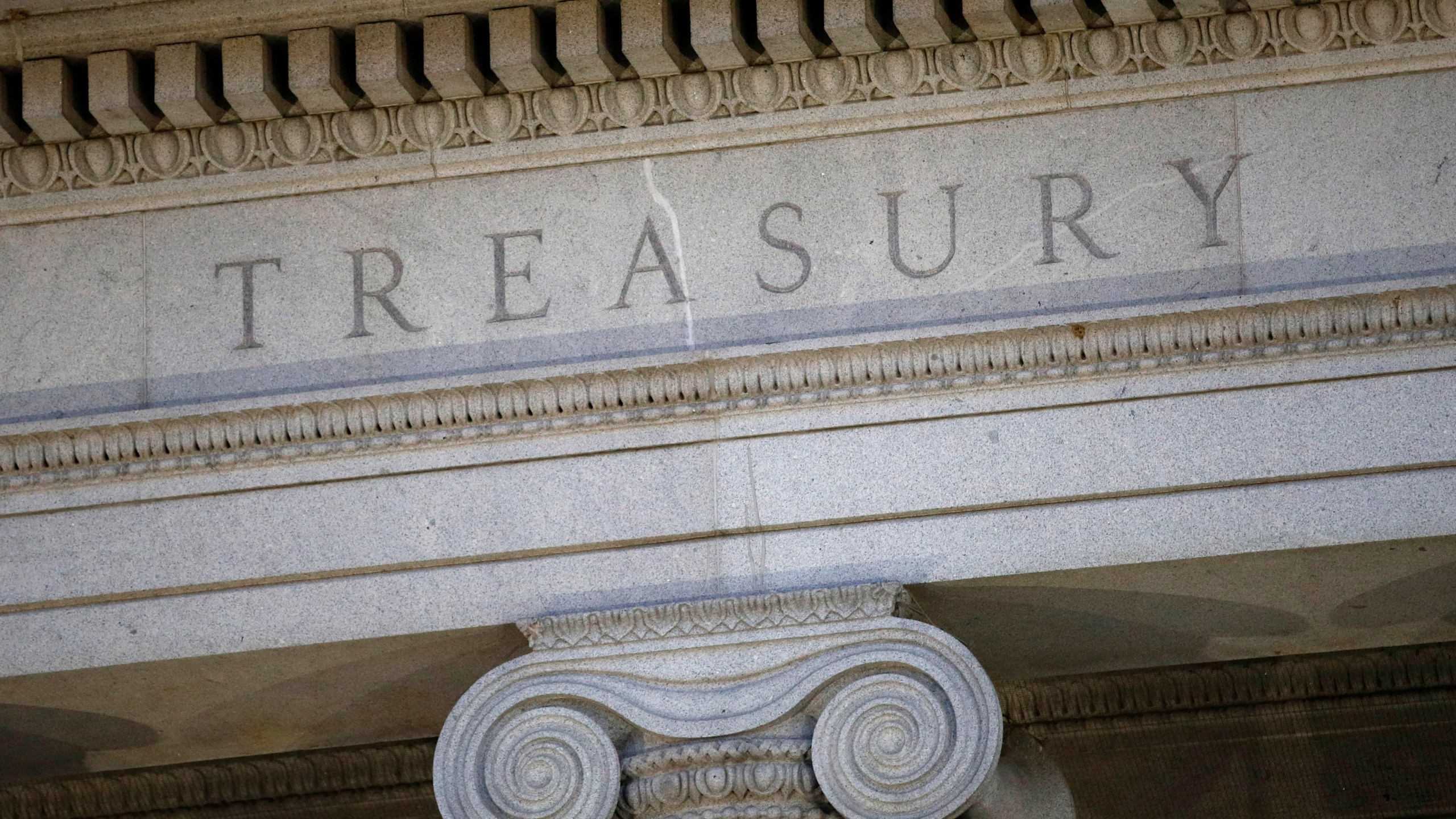 FILE- The U.S. Treasury Department building is shown at dusk in Washington on June 6, 2019. The U.S. on Tuesday, Dec. 5, 2023, imposed sanctions on a Belgian involved in procuring electronics for the Russian military, his companies and a group of Belarusian firms and people tied to Russia's invasion of Ukraine. (AP Photo/Patrick Semansky, File)