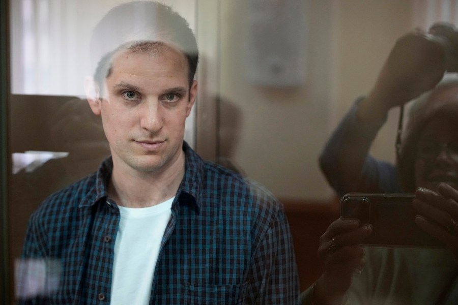 FIle - Wall Street Journal reporter Evan Gershkovich stands in a glass cage in a courtroom at the Moscow City Court, in Moscow, Russia, Oct. 10, 2023. The Biden administration says its made a new and significant offer aimed at securing the release of American detainees Paul Whelan and Evan Gershkovich, but Russia has rejected the offer. (AP Photo/Alexander Zemlianichenko, File)