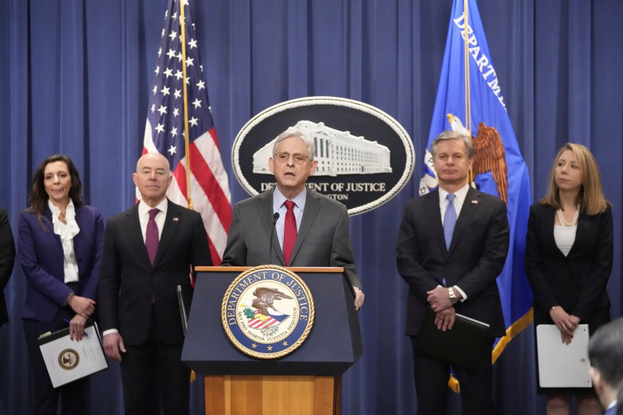 Attorney General Merrick Garland speaks with reporters during a news conference at the Department of Justice, Wednesday, Dec. 6, 2023, in Washington, with from left, Assistant Attorney General Nicole M. Argentieri of the Criminal Division, Secretary of Homeland Security Alejandro Mayorkas, FBI Director Christopher Wray and U.S. Attorney Jessica Aber for the Eastern District of Virginia. (AP Photo/Mark Schiefelbein)