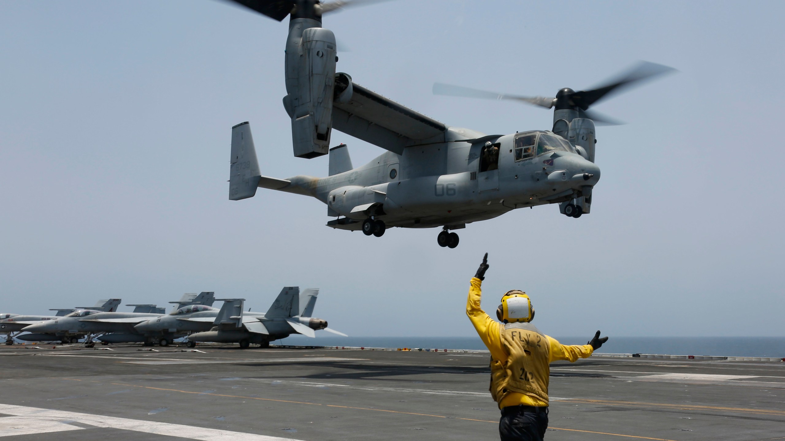 FILE -In this image provided by the U.S. Navy, Aviation Boatswain's Mate 2nd Class Nicholas Hawkins, signals an MV-22 Osprey to land on the flight deck of the USS Abraham Lincoln in the Arabian Sea on May 17, 2019. When the U.S. military took the extraordinary step of grounding its fleet of V-22 Ospreys this week, it wasn't reacting just to the recent deadly crash of the aircraft off the coast of Japan. The aircraft has had a long list of problems in its short history. (Mass Communication Specialist 3rd Class Amber Smalley/U.S. Navy via AP)