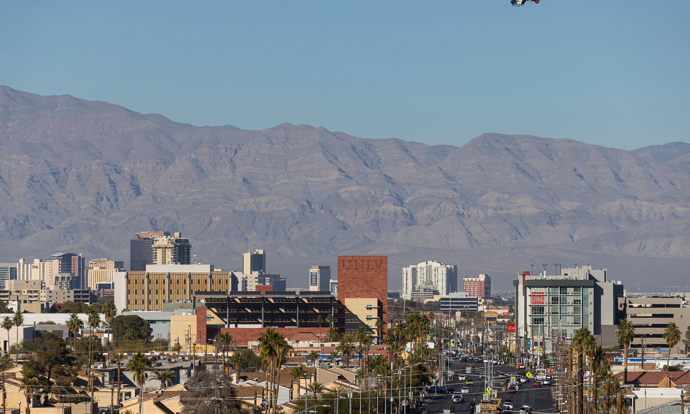 A police helicopter flies overhead during a shooting on the University of Nevada, Las Vegas, campus on Wednesday, Dec. 6, 2023, in Las Vegas. (Chase Stevens/Las Vegas Review-Journal via AP)