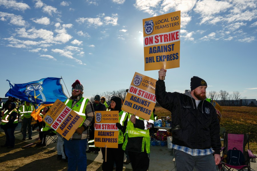 Teamsters protest at Cincinnati/Northern Kentucky International Airport near the DHL Express Hub Friday, Dec. 8, 2023, in Erlanger ,Ky. More than 1,000 union members at DHL walked off the job at Cincinnati/Northern Kentucky International Airport, a critical logistics hub for the package delivery company, during the busiest time of the year. The Teamsters say they are protesting unfair labor practices at the DHL Express hub. (AP Photo/Carolyn Kaster)