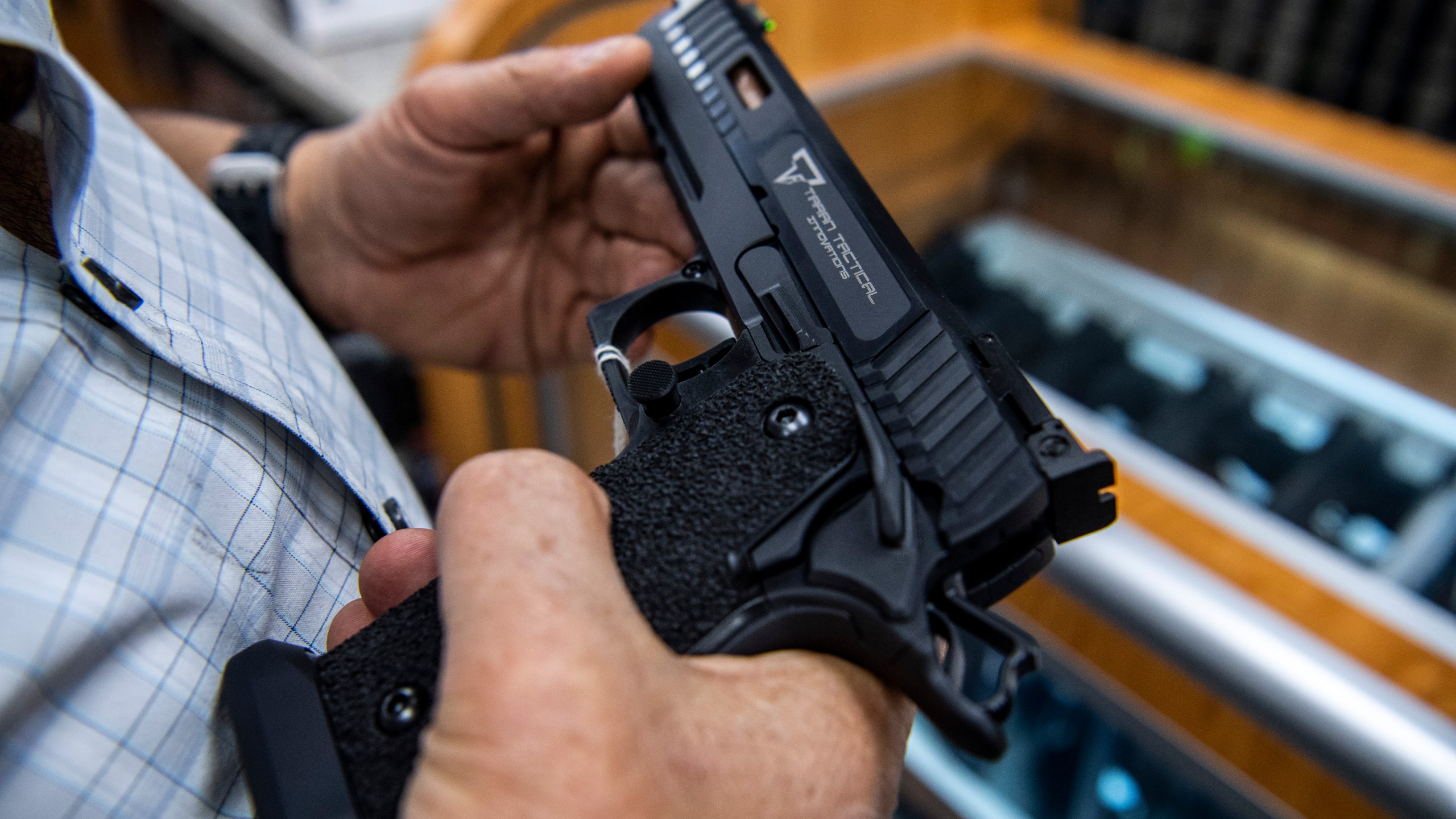 FILE - A customer checks out a hand gun that is for sale and on display at SP firearms on June 23, 2022, in Hempstead, New York. New York can continue to enforce laws banning firearms in sensitive locations, a federal appeals court ruled Friday, Dec. 8, 2023 in its first broad review of a host of new gun rules passed in the state after a landmark Supreme Court ruling last year.(AP Photo/Brittainy Newman, File)