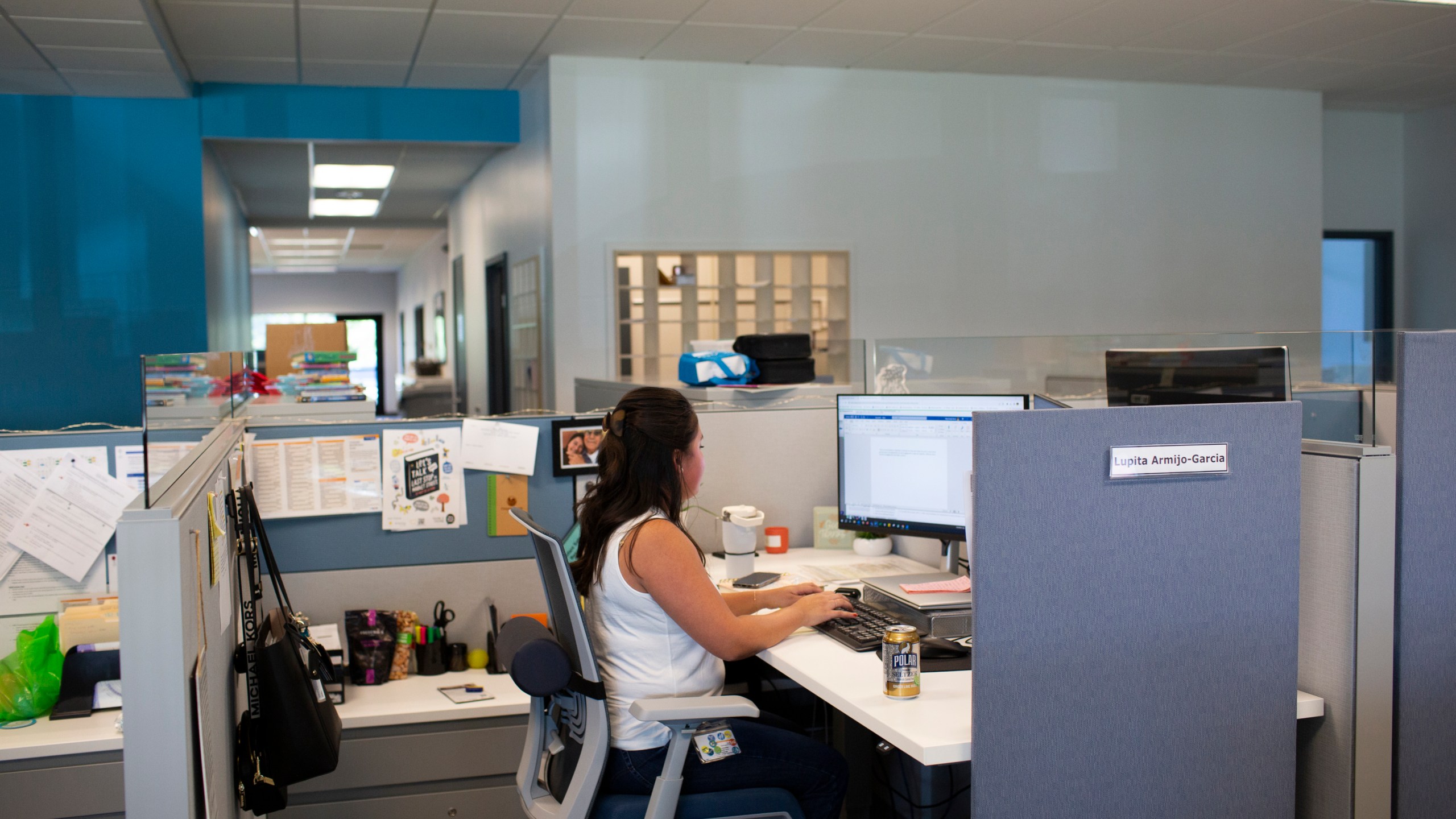 File - Social worker Lupita Armijo-Garcia works at her desk in the Ottawa County, Mich., Department of Public Health office, Tuesday, Sept. 5, 2023, in Holland, Mich. On Friday, the U.S. government issues its November jobs report. (AP Photo/Kristen Norman, File)