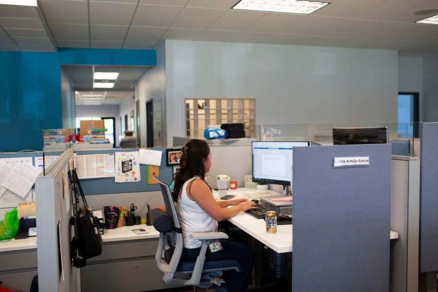 File - Social worker Lupita Armijo-Garcia works at her desk in the Ottawa County, Mich., Department of Public Health office, Tuesday, Sept. 5, 2023, in Holland, Mich. On Friday, the U.S. government issues its November jobs report. (AP Photo/Kristen Norman, File)