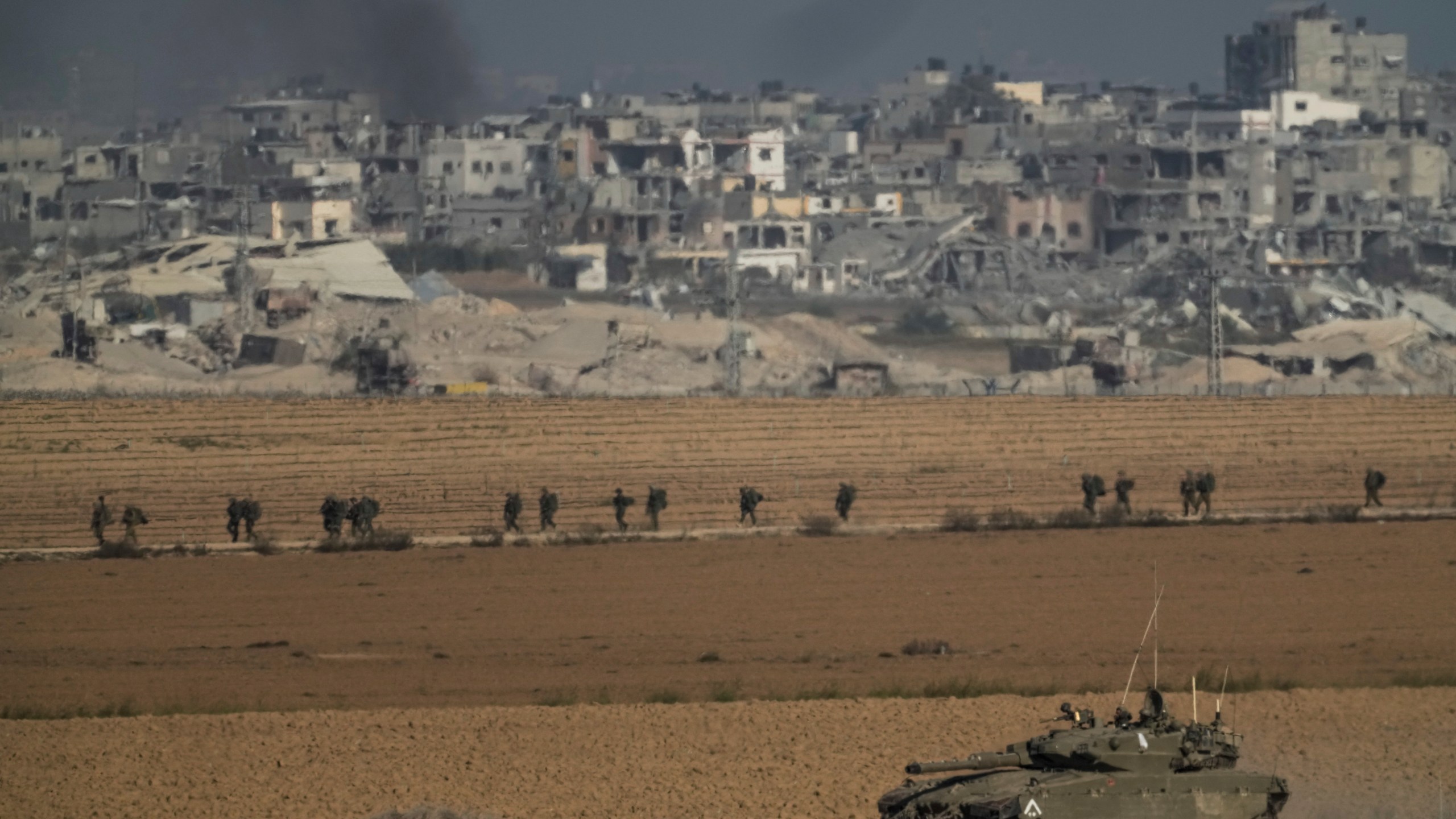 Israeli troops are seen near the Gaza Strip border, in southern Israel on Sunday, Dec. 10, 2023. (AP Photo/Leo Correa)