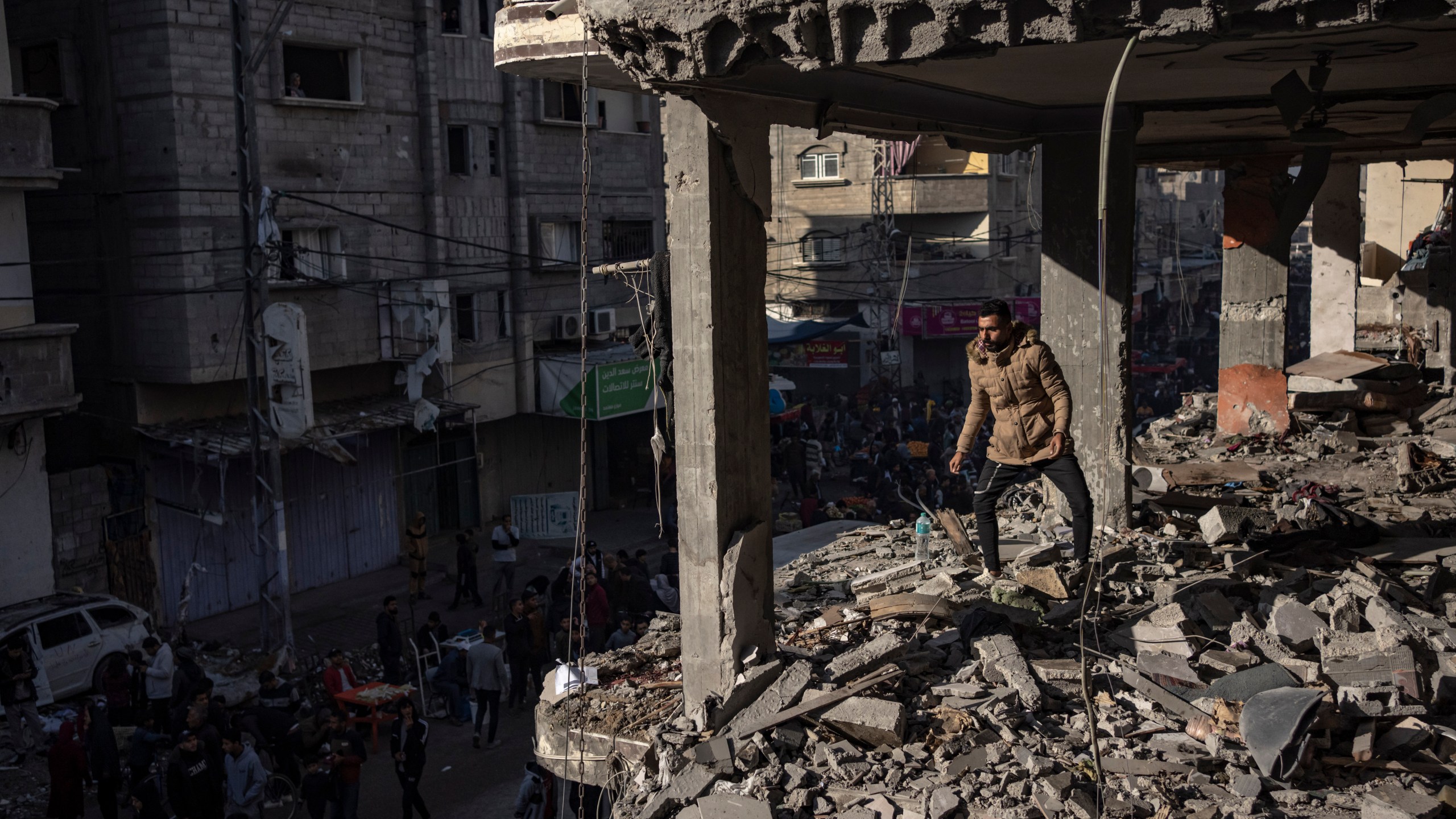 Palestinians check a house destroyed in the Israeli bombardment on Rafah, Gaza Strip, Monday, Dec. 11, 2023. (AP Photo/Fatima Shbair)