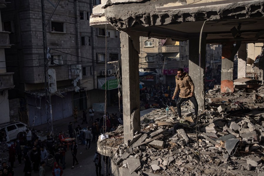 Palestinians check a house destroyed in the Israeli bombardment on Rafah, Gaza Strip, Monday, Dec. 11, 2023. (AP Photo/Fatima Shbair)