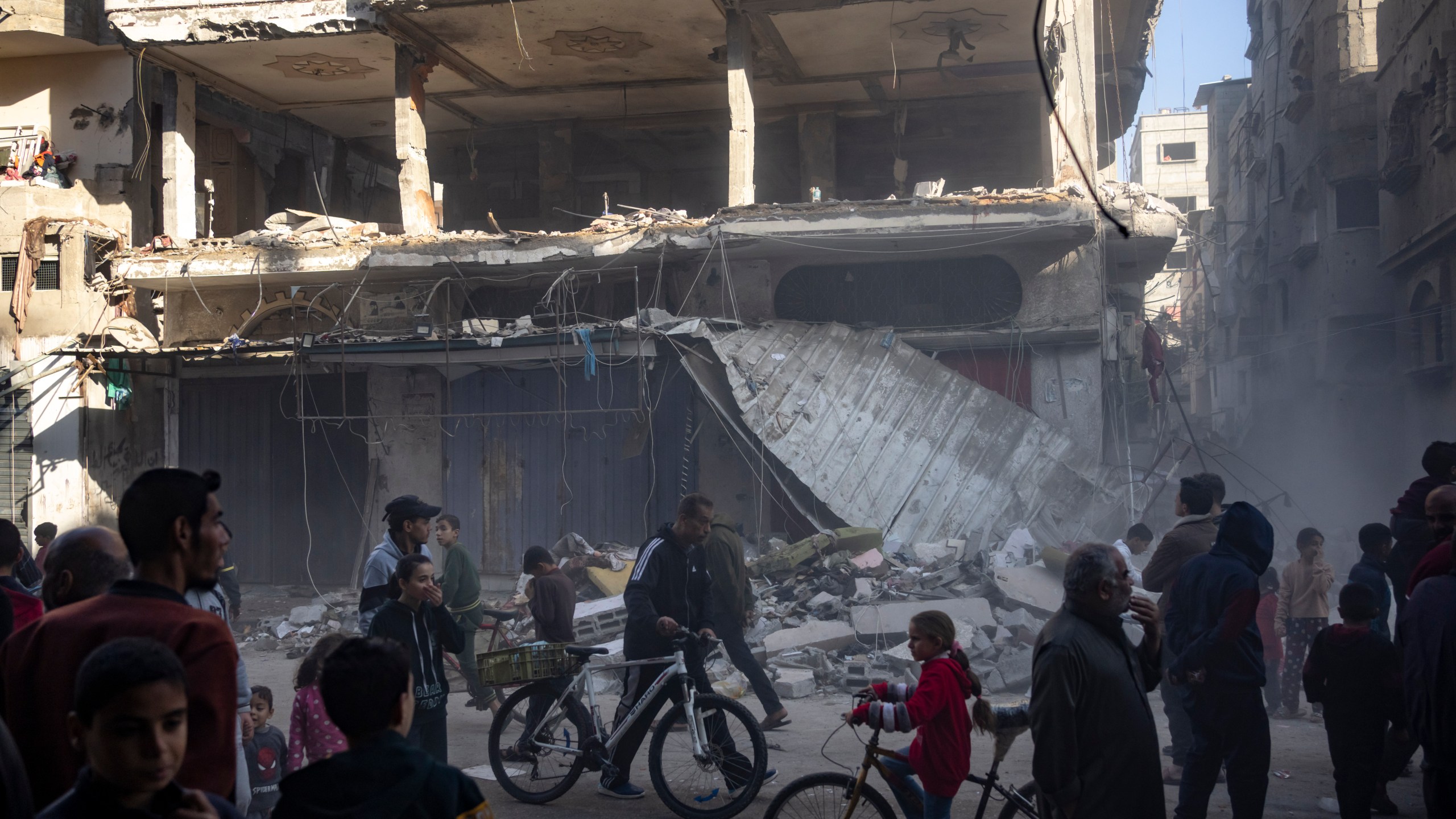 Palestinians check a house destroyed in the Israeli bombardment on Rafah, Gaza Strip, Monday, Dec. 11, 2023. (AP Photo/Fatima Shbair)