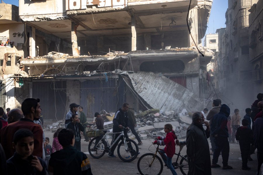 Palestinians check a house destroyed in the Israeli bombardment on Rafah, Gaza Strip, Monday, Dec. 11, 2023. (AP Photo/Fatima Shbair)