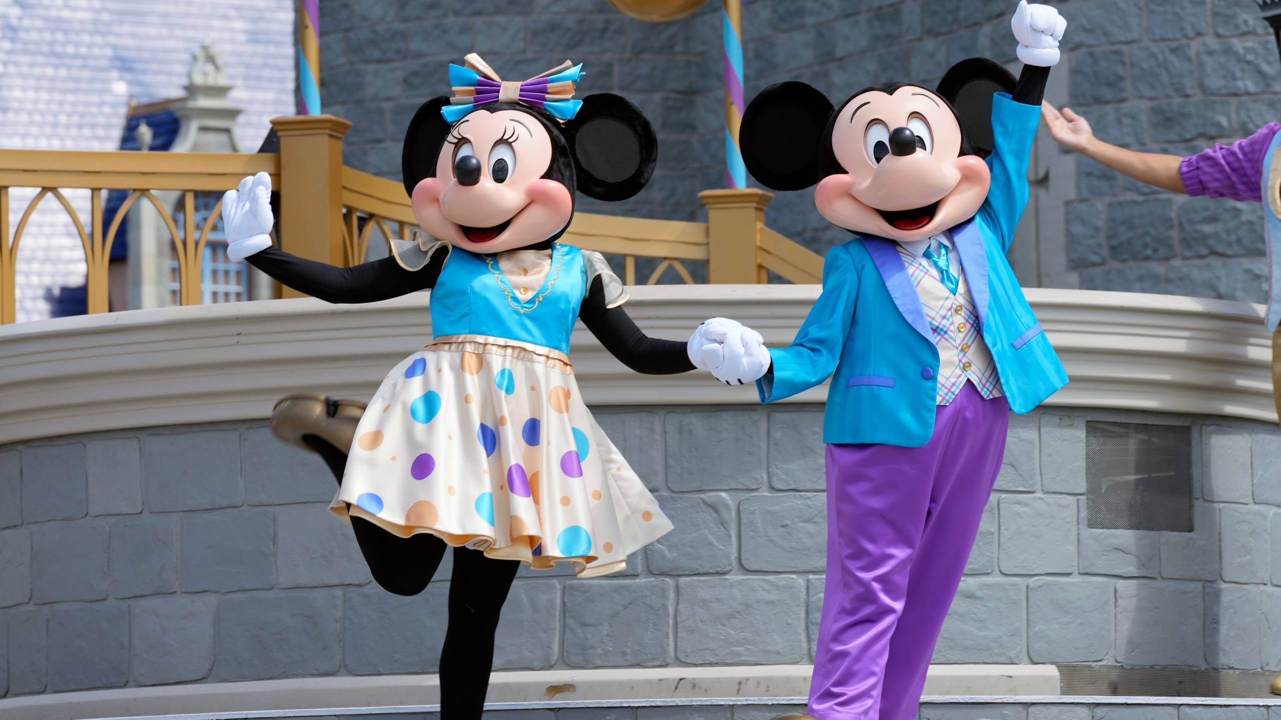 FILE - Minnie and Mickey Mouse perform for guests during a musical show in the Magic Kingdom at Walt Disney World Friday, July 14, 2023, in Lake Buena Vista, Fla. Disney on Tuesday, Nov. 14, released a study showing its economic impact in Florida at more than $40 billion, as it battles in courts with Florida Gov. Ron DeSantis and his appointees over their takeover of the district that governs the entertainment company's massive resort in central Florida.(AP Photo/John Raoux, File)