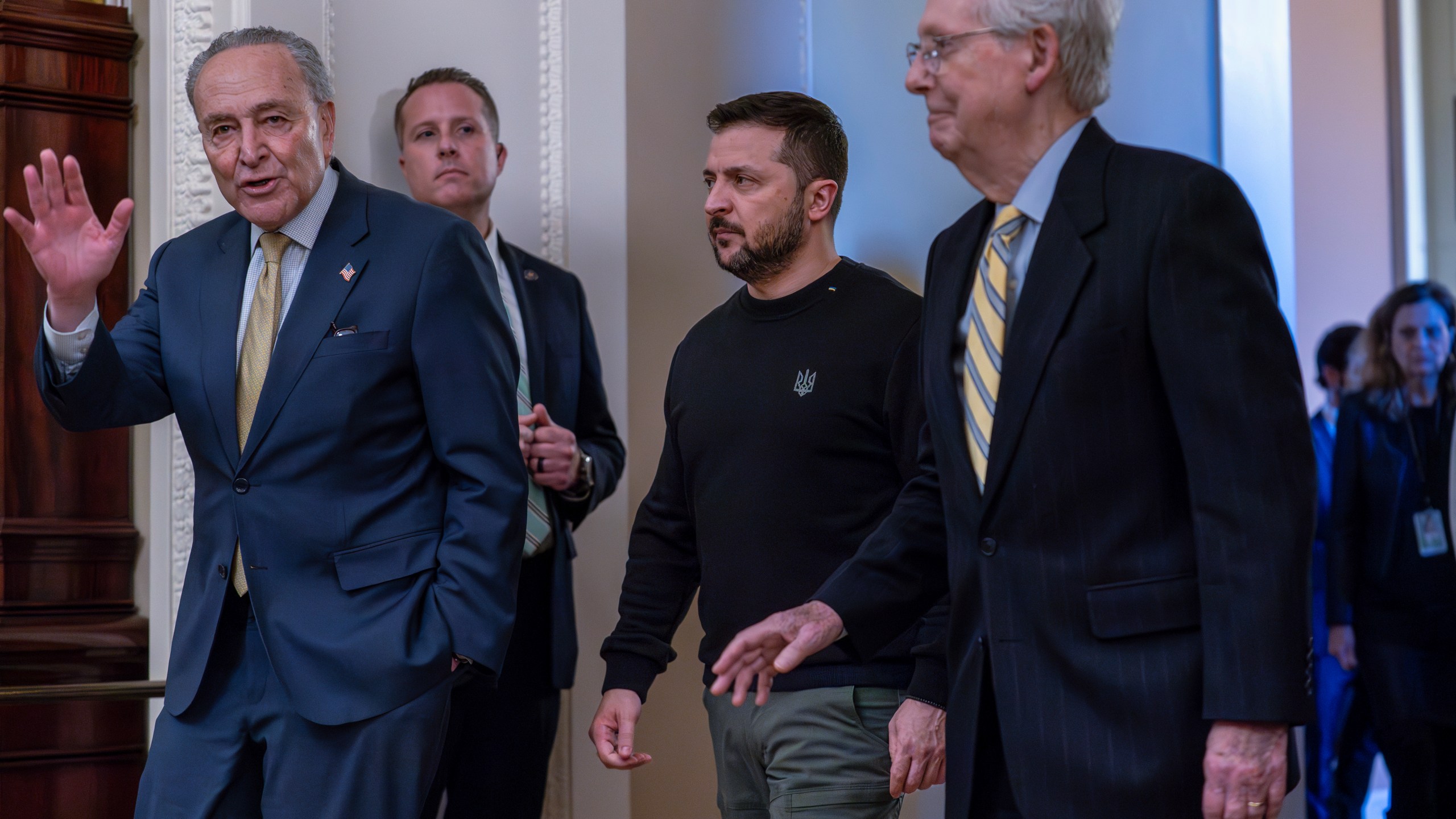 From left, Senate Majority Leader Chuck Schumer, D-N.Y., Ukrainian President Volodymyr Zelenskyy, and Minority Leader Mitch McConnell, R-Ky., leave a meeting at the Capitol in Washington where Zelenskyy implored Congress to break its deadlock and approve continued wartime funding for Ukraine, Tuesday, Dec. 12, 2023. (AP Photo/J. Scott Applewhite)