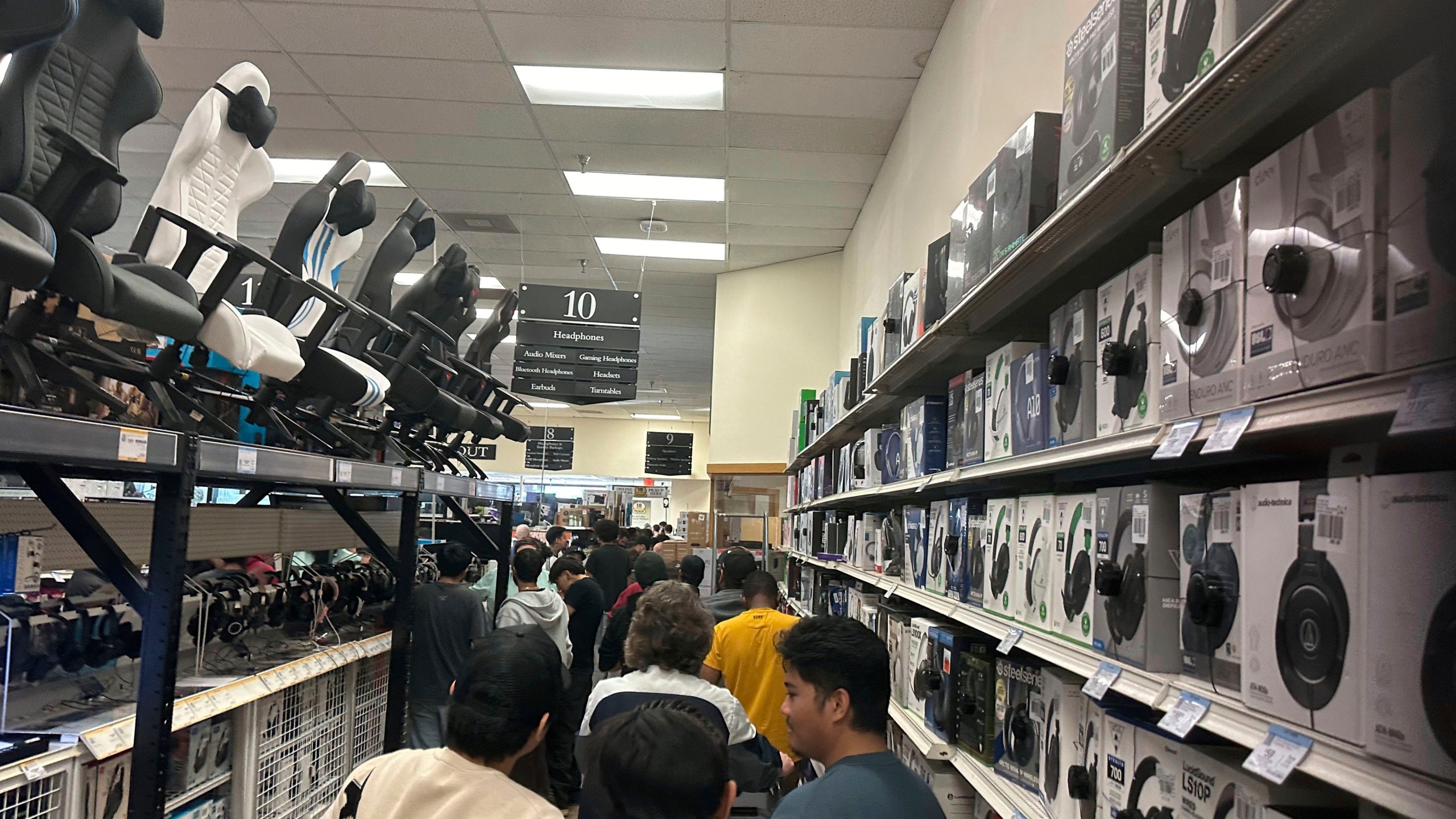 File - Patrons stand in a line that runs around the interior of the building on Black Friday, Nov, 24, 2023 at a Micro Center store in Yetta, Ga. On Tuesday, the Labor Department issues its report on inflation at the consumer level in November. (AP Photo/Mike Stewart, File)