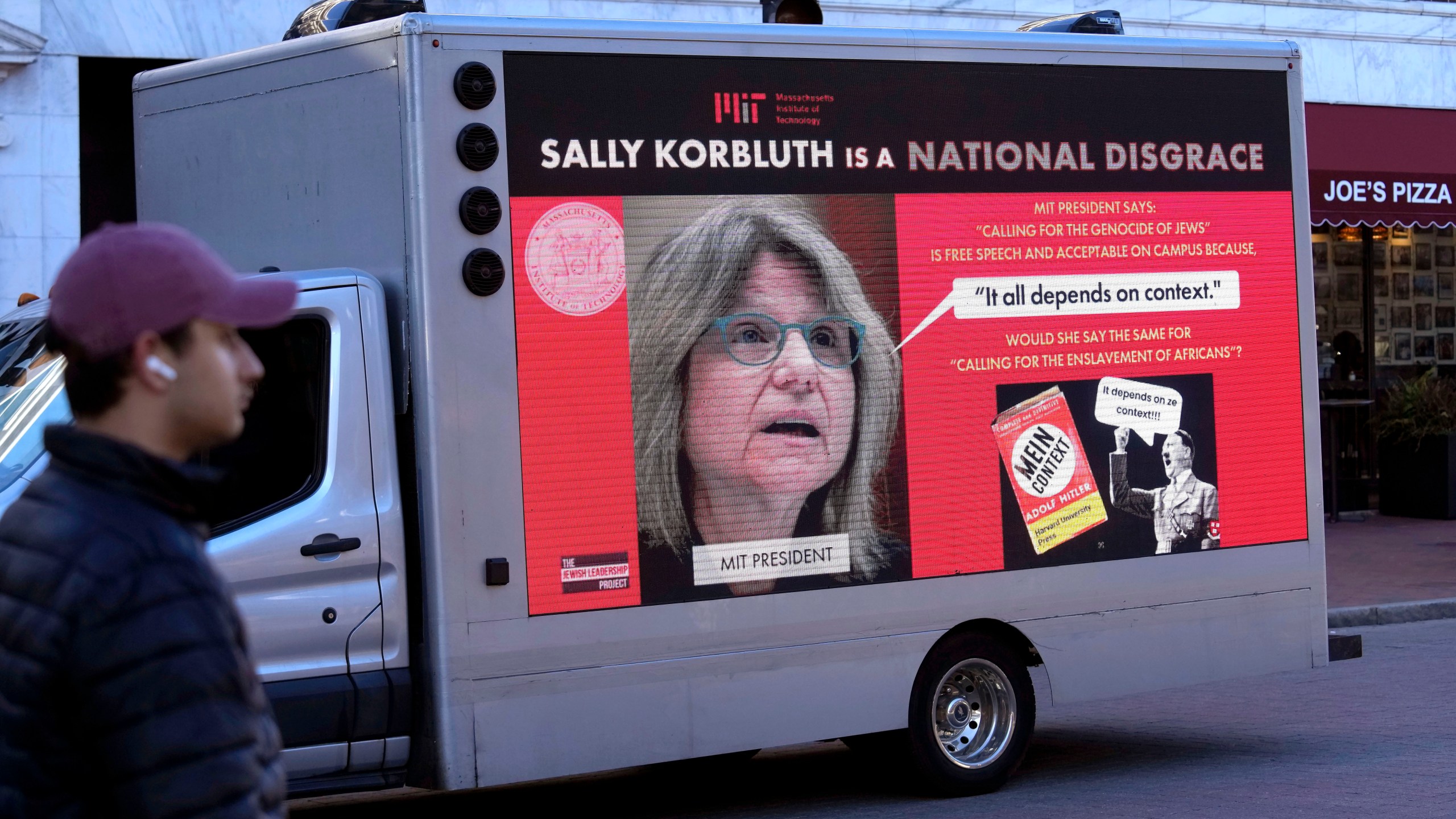 A truck with electronic panels drives along a street Tuesday, Dec. 12, 2023, near Harvard University, in Cambridge, Mass., while displaying messages calling attention to a recent controversy involving testimony to Congress by presidents of three prestigious schools, including Harvard University, MIT, and the University of Pennsylvania. Harvard President Claudine Gay will remain leader of Harvard following her comments last week at a congressional hearing on antisemitism, the university's highest governing body announced Tuesday. (AP Photo/Steven Senne)