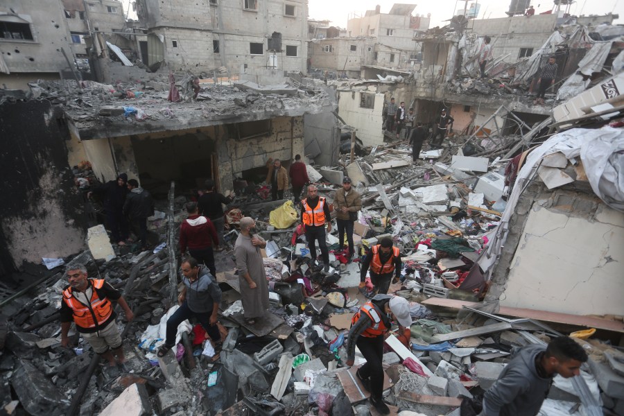 Palestinians look for survivors of the Israeli bombardment of the Gaza Strip in Rafah on Tuesday, Dec. 12, 2023. (AP Photo/Hatem Ali)