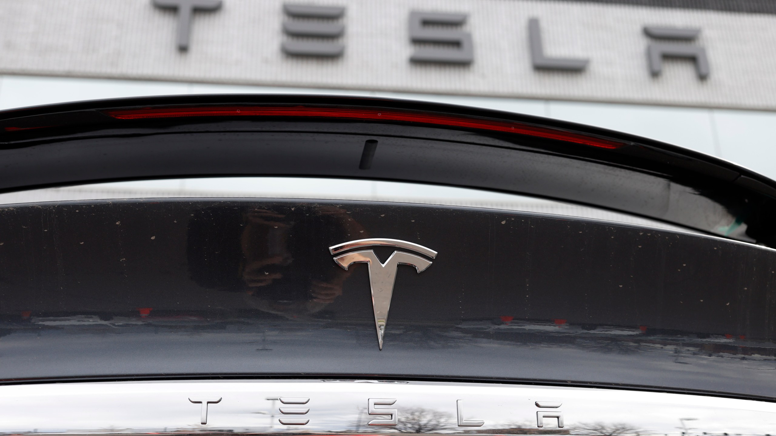 FILE - The Tesla company logo shines off the rear deck of an unsold 2020 Model X at a Tesla dealership, April 26, 2020, in Littleton, Colo. Tesla is recalling more than 2 million vehicles across its model lineup to fix a defective system that’s supposed to ensure drivers are paying attention when they use Autopilot. Documents posted by U.S. safety regulators say the company will send out a software update to fix the problems. (AP Photo/David Zalubowski, File)