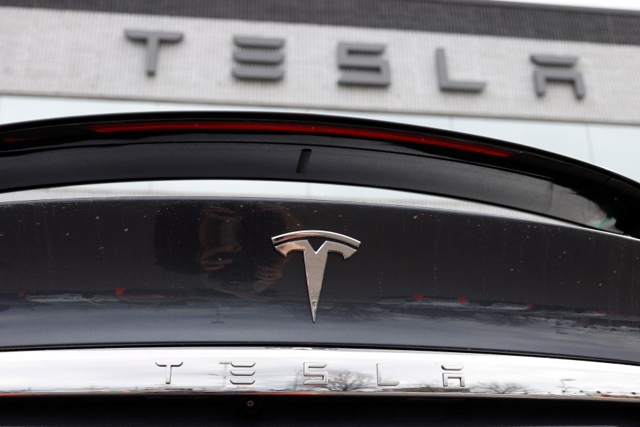 FILE - The Tesla company logo shines off the rear deck of an unsold 2020 Model X at a Tesla dealership, April 26, 2020, in Littleton, Colo. Tesla is recalling more than 2 million vehicles across its model lineup to fix a defective system that’s supposed to ensure drivers are paying attention when they use Autopilot. Documents posted by U.S. safety regulators say the company will send out a software update to fix the problems. (AP Photo/David Zalubowski, File)