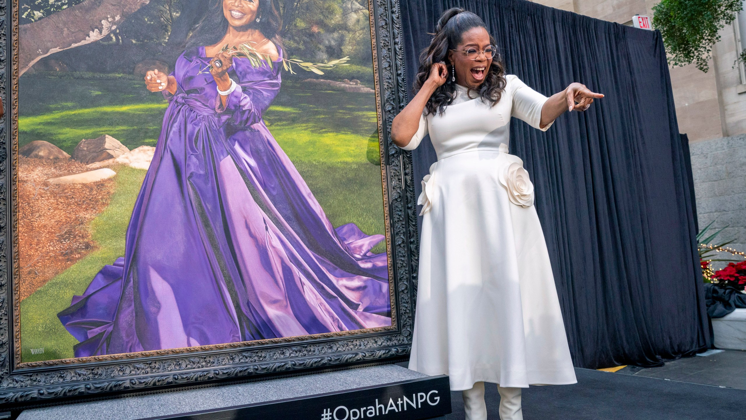 Oprah Winfrey shouts out to a member of the crowd while next to her portrait, Wednesday, Dec. 13, 2023, during a portrait unveiling ceremony at the Smithsonian's National Portrait Gallery in Washington. (AP Photo/Jacquelyn Martin)