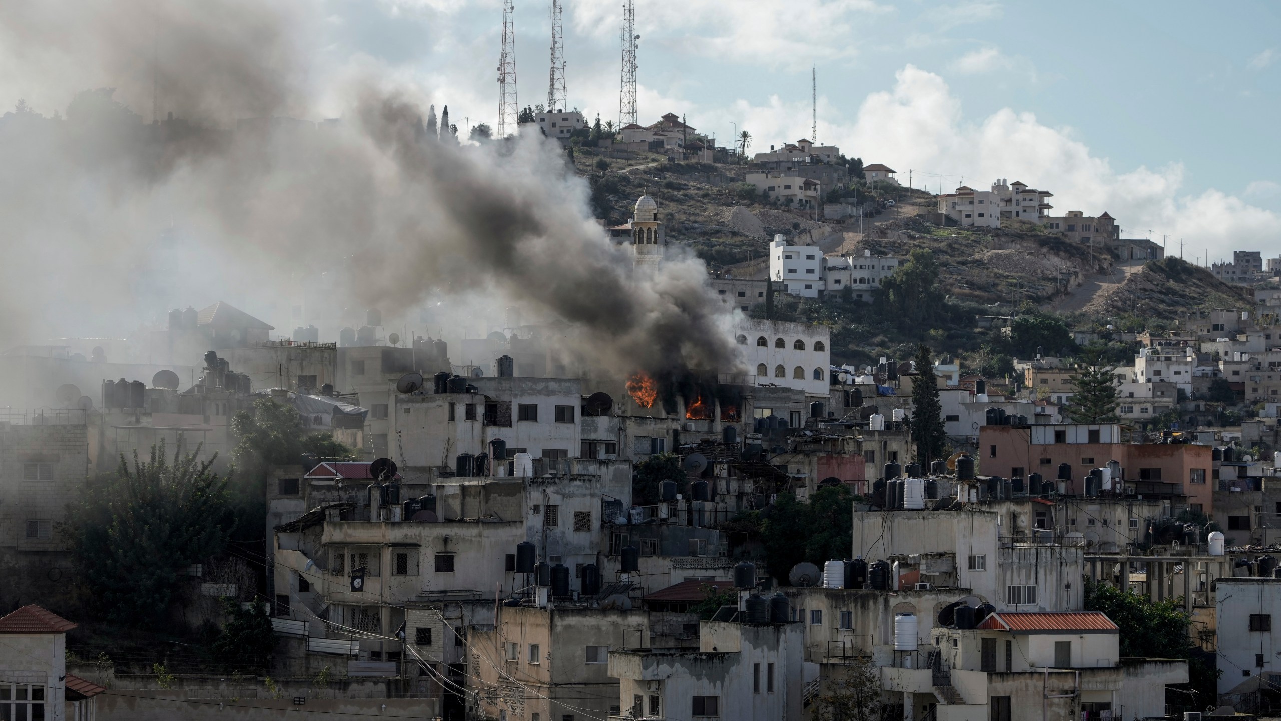 Fire and smoke rises during an Israeli army operation in Jenin, West Bank, Wednesday, Dec. 13, 2023. (AP Photo/Majdi Mohammed)