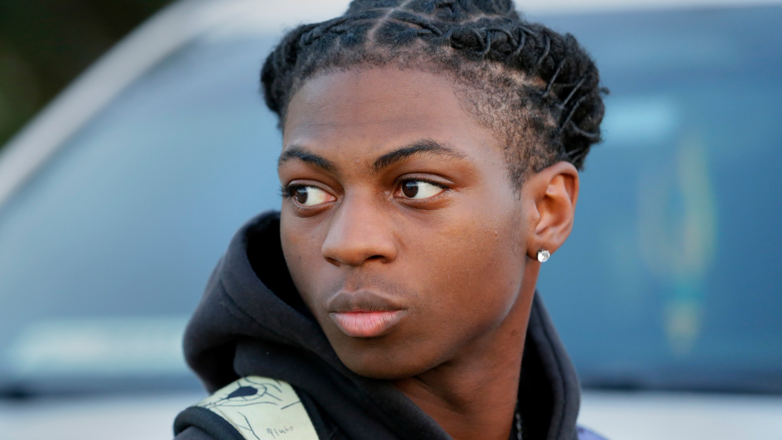 FILE - Darryl George, an 18-year-old junior, looks on before walking into Barbers Hill High School after serving an in-school suspension for not cutting his hair, Sept. 18, 2023, in Mont Belvieu, Texas. The Texas high school Black student who has been disciplined and kept away from his classroom for months for refusing to change his hairstyle is not likely to be back with his regular classmates anytime soon. (AP Photo/Michael Wyke, File)