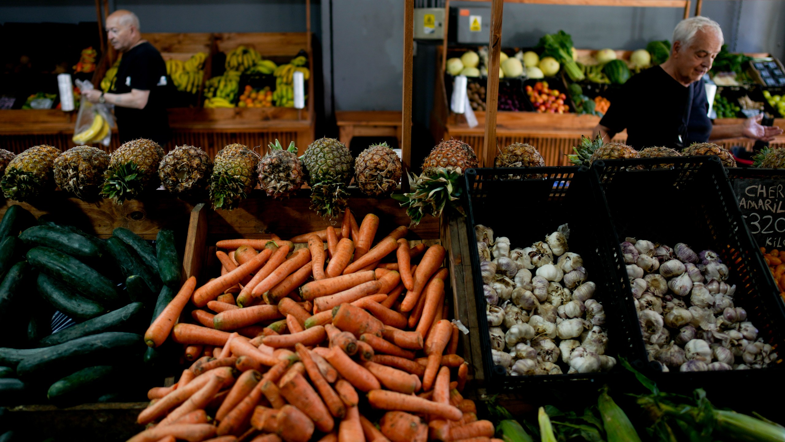 File - Shoppers buy vegetables in Buenos Aires, Argentina, Monday, Dec. 11, 2023. South America's second largest economy is suffering 143% annual inflation. (AP Photo/Natacha Pisarenko, File)