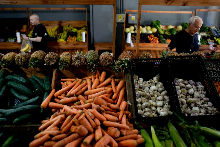 File - Shoppers buy vegetables in Buenos Aires, Argentina, Monday, Dec. 11, 2023. South America's second largest economy is suffering 143% annual inflation. (AP Photo/Natacha Pisarenko, File)