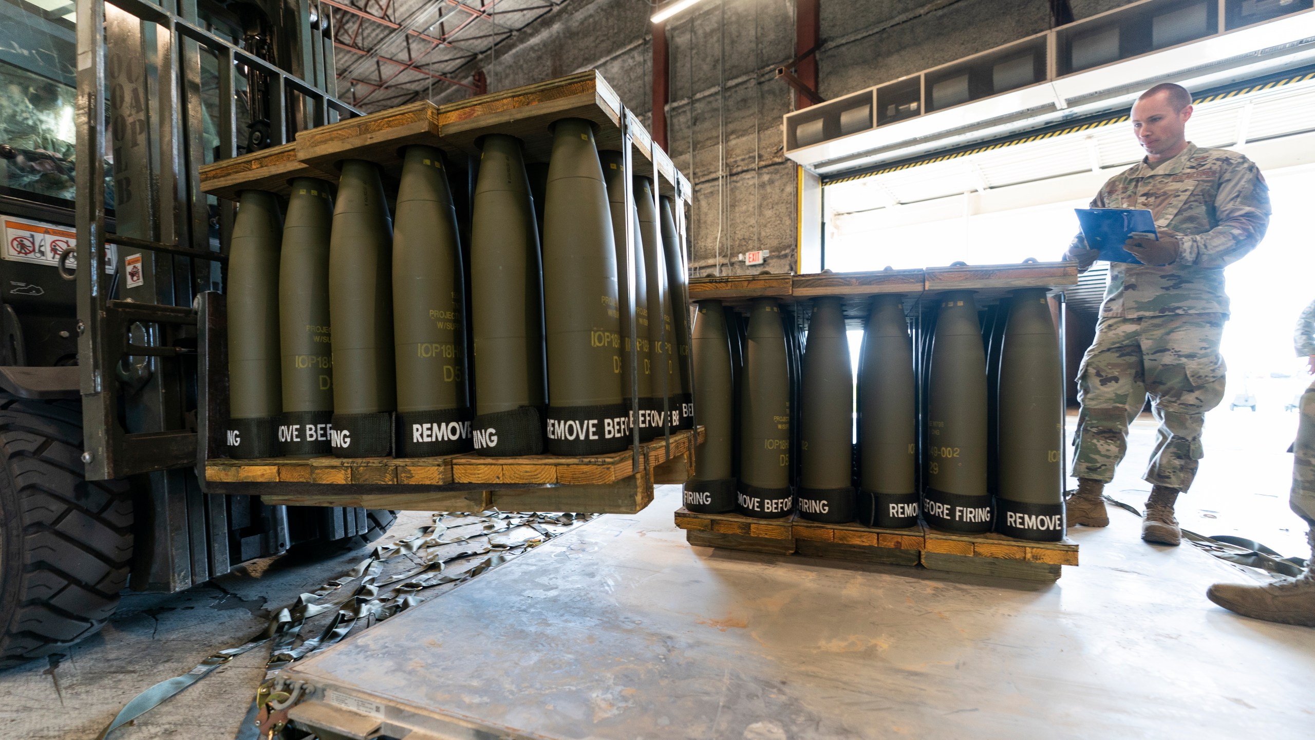 FILE - U.S. Air Force Staff Sgt. Cody Brown, right, with the 436th Aerial Port Squadron, checks pallets of 155 mm shells ultimately bound for Ukraine, April 29, 2022, at Dover Air Force Base, Del. The White House says funding for Ukraine has run out and it has been increasing pressure on Congress to pass stalled legislation to support the war against Russia. On Tuesday, however, President Joe Biden touted a new military aid package worth $200 million for Ukraine. That may seem contradictory, but it’s due to the complex programs used to send aid to Ukraine. (AP Photo/Alex Brandon, File)