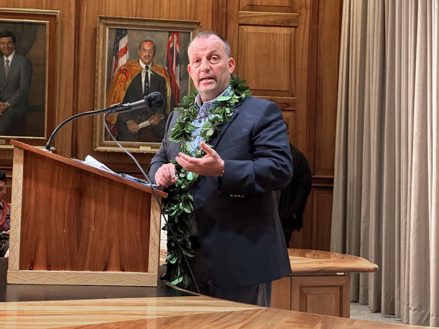 Hawaii Gov. Josh Green speaks at a news conference in Honolulu on Friday, Dec. 15, 2023. Green on Friday said he wants 3,000 condos and homes normally rented to Maui tourists on a short-term basis converted to long-term housing for displaced wildfire survivors who are now living in hotels and will use his emergency powers to achieve this if necessary.(AP Photo/Audrey McAvoy)