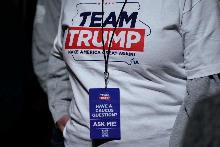 FILE - An audience member waits for former President Donald Trump to arrive at a commit to caucus rally, Sunday, Oct. 29, 2023, in Sioux City, Iowa. Trump is pushing his supporters to deliver a blowout win in the Iowa caucuses one month away. Unlike his first time in the caucuses, Trump’s campaign is now run by Iowa veterans who are not just locking in caucus commitments but building a formidable organization to try to lock in his lead. (AP Photo/Charlie Neibergall, File)