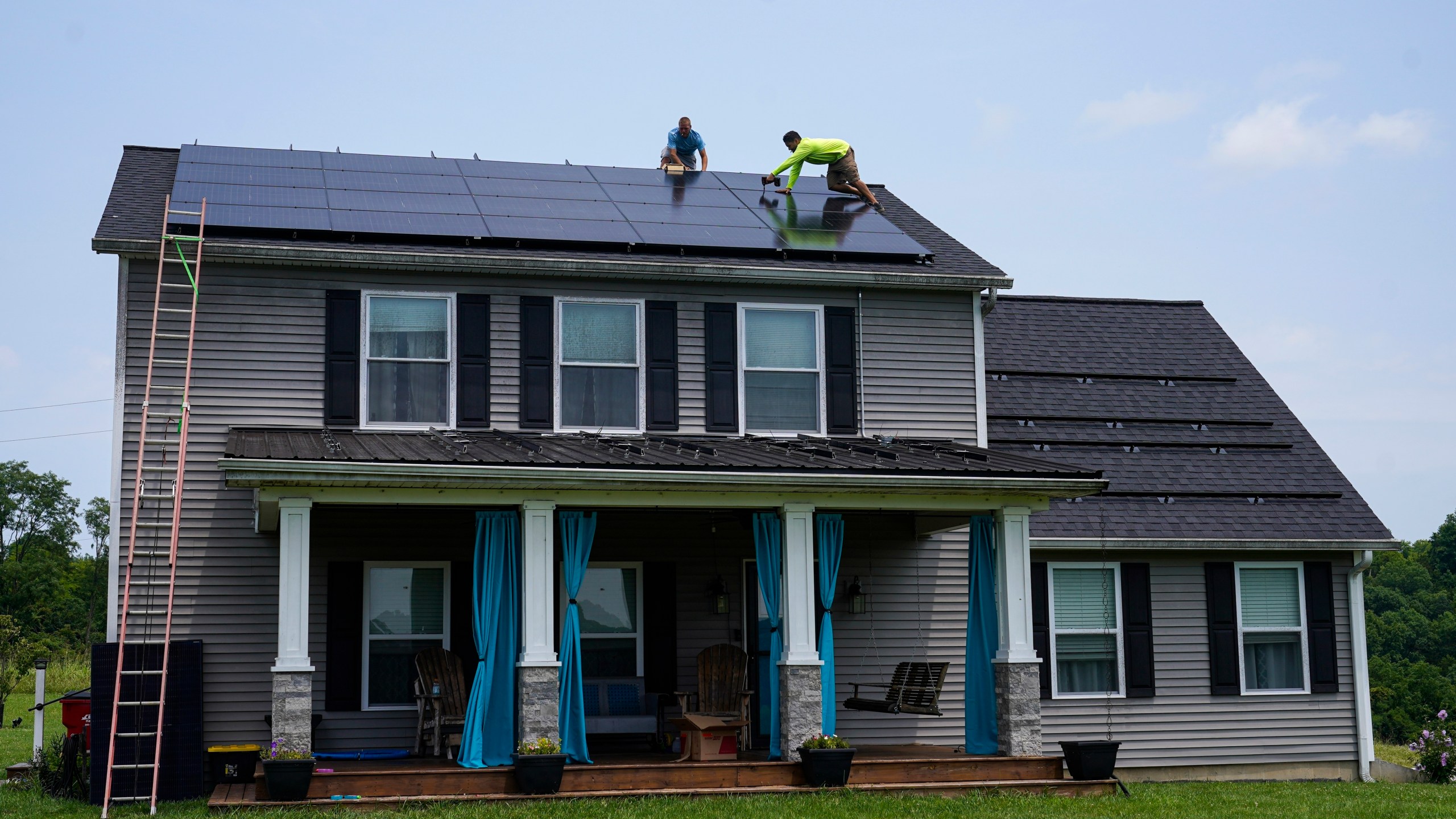 FILE - Solar panels are installed on the roof of a home in Frankfort, Ky., Monday, July 17, 2023. Residential solar is gaining traction in the U.S., with about 4.5 million homes now with solar rooftops. The share of electric vehicles in the U.S. is also growing. Many people with EVs become interested in charging them on solar energy, if they own their own roofs. (AP Photo/Michael Conroy, File)