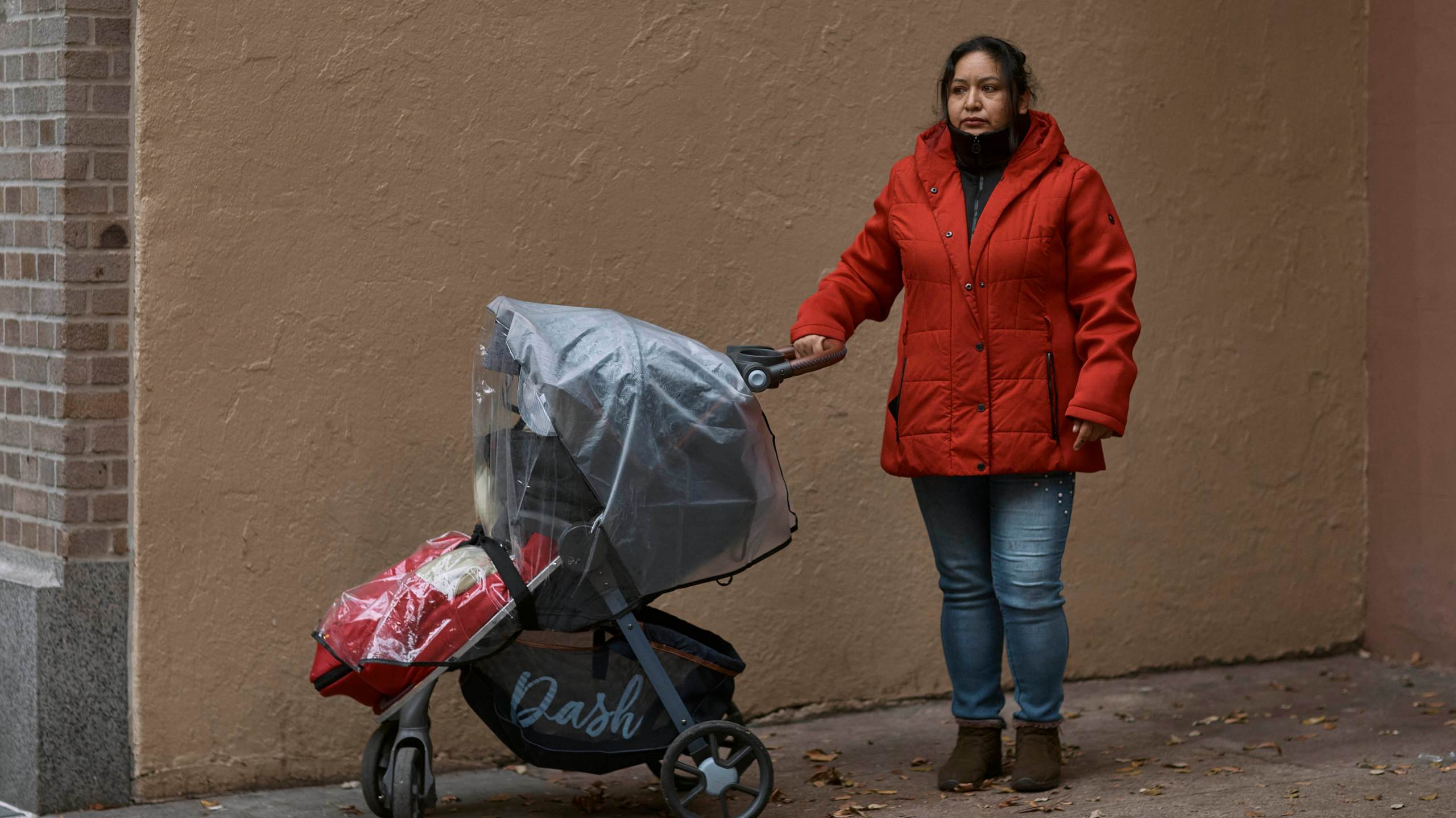 Migrant Karina Obando, from Ecuador poses for a portrait in front of the Row Hotel that serves as migrant shelter together with her 3-year-old daughter Maily Caiza on Tuesday, Dec. 12, 2023, in New York. Obando who lives with Maily, and her 11-year-old son Efren, in the Row Hotel that serves as migrant shelter, has received an eviction notice. (AP Photo/Andres Kudacki)