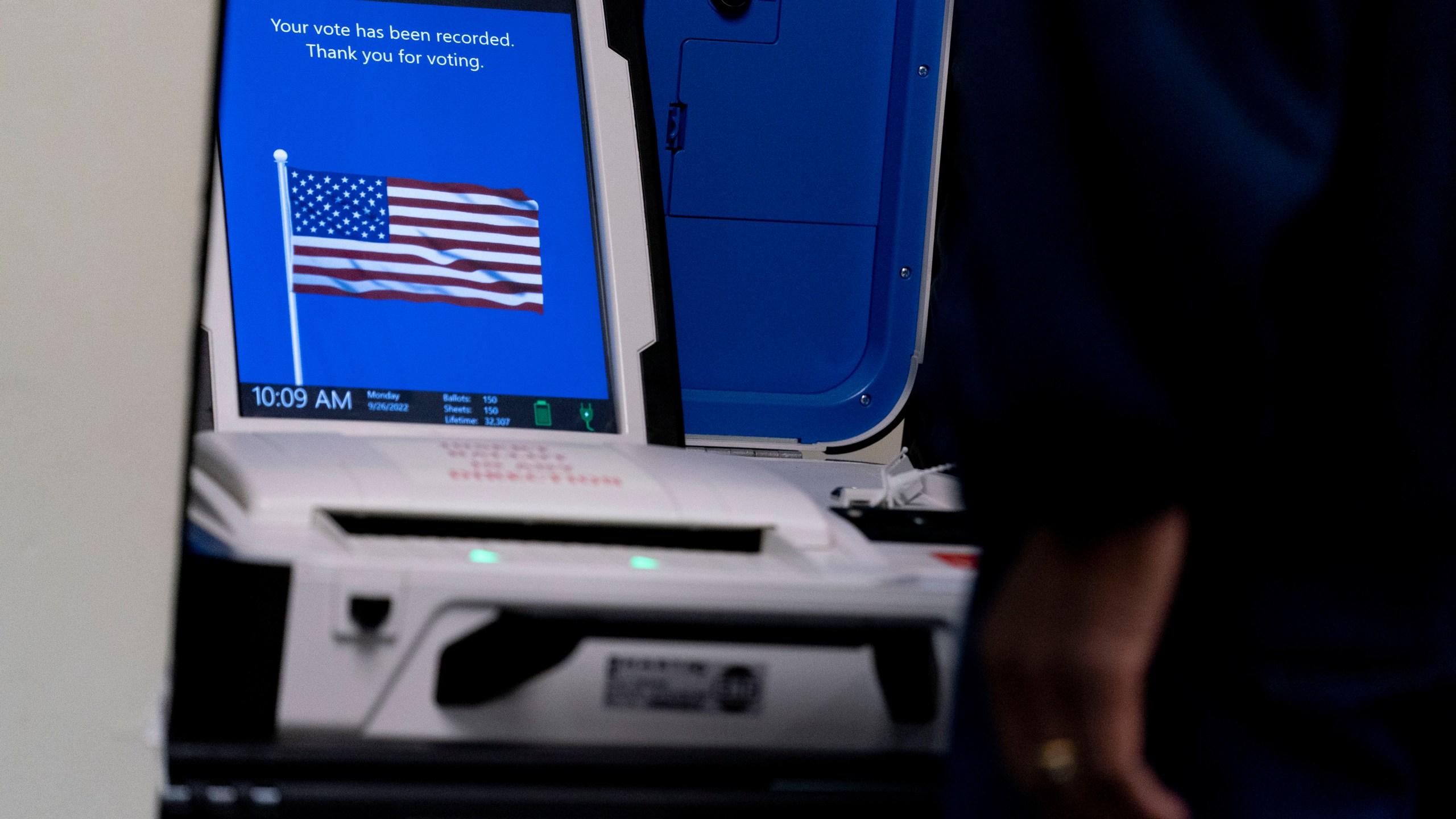 FILE - A voter submits their ballot at an early voting location in Alexandria, Va., Sept. 26, 2022. A declassified U.S. government report says foreign hackers did not change vote totals or otherwise compromise the integrity of federal elections last year in the United States. The report does identify multiple instances in which hackers linked to Iran, China and Russia connected to election infrastructure, scanned state government websites and copied voter information. (AP Photo/Andrew Harnik, File)