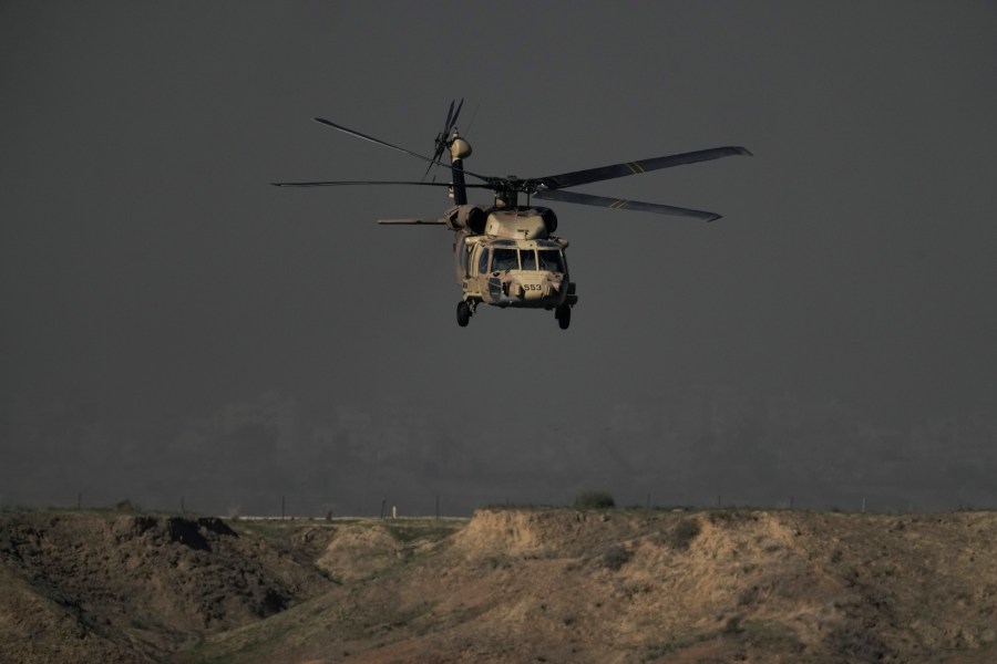 Israeli military helicopter flies out of the Gaza Strip, Monday, Dec. 18, 2023. (AP Photo/Leo Correa)