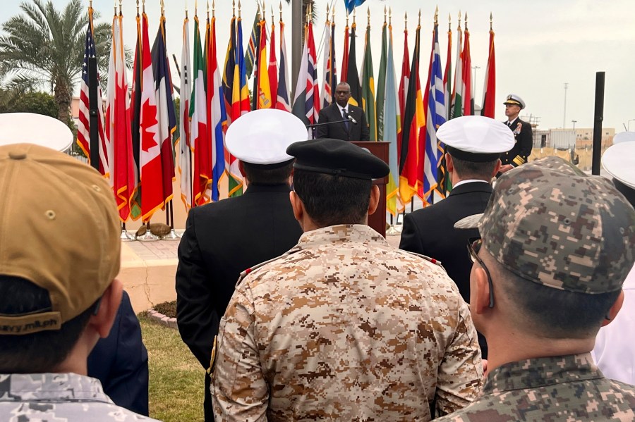 U.S. Defense Secretary Lloyd Austin, rear, addresses members of an international maritime task force protecting commercial ships in the Red Sea at U.S. Navy Central Command headquarters in Manama, Bahrain, Tuesday, Dec. 19, 2023. Due to a sharp increase in attacks on commercial vessels transiting there in the last few weeks the U.S. has announced a new mission, Operation Prosperity Guardian, to get additional countries to send ships and intelligence support. (AP Photo/Tara Copp)