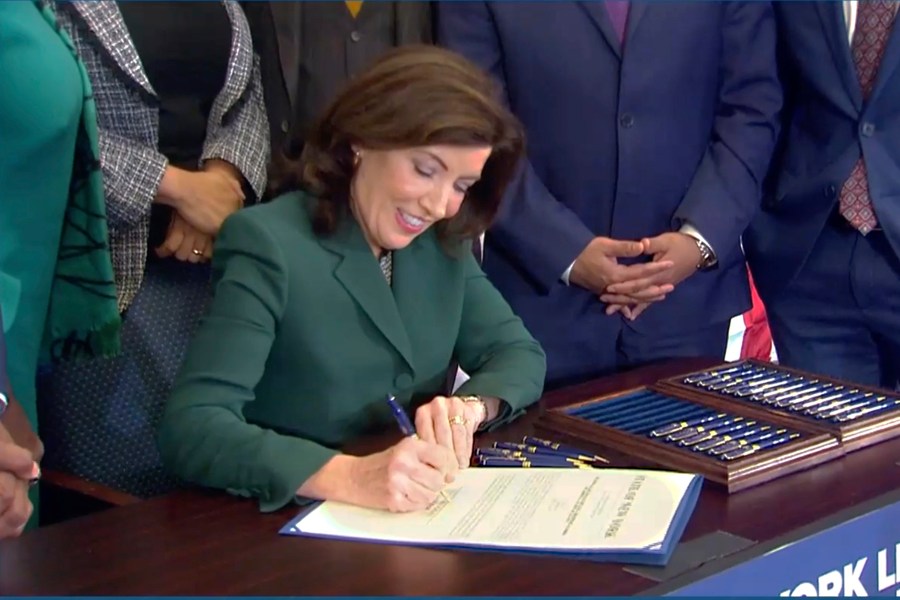 CORRECTS CITY TO NEW YORK - This image from video provided by the Office of The Governor shows New York Gov. Kathy Hochul as she signs a bill in New York, Tuesday, Dec. 19, 2023, to create a commission tasked with considering reparations to address the persistent, harmful effects of slavery in the state. (Office of the Governor via AP)