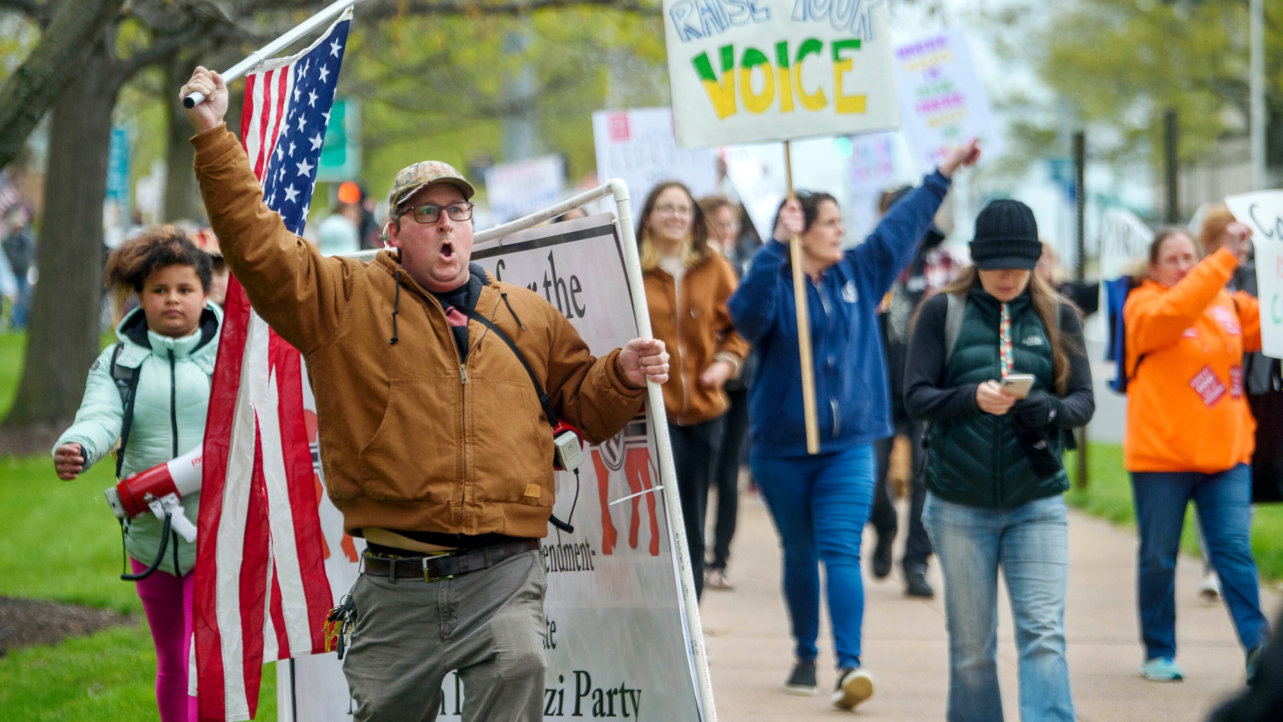 FILE - Opponents of a bill to repeal Connecticut's religious exemption for required school vaccinations march down Capitol Avenue before the State Senate voted on legislation on April 27, 2021, in Hartford, Conn. Connecticut eliminated its longstanding religious waiver for vaccinations in 2021, joining California, West Virginia, New York and Maine in allowing only medical exemptions. (Mark Mirko/Hartford Courant via AP, File)