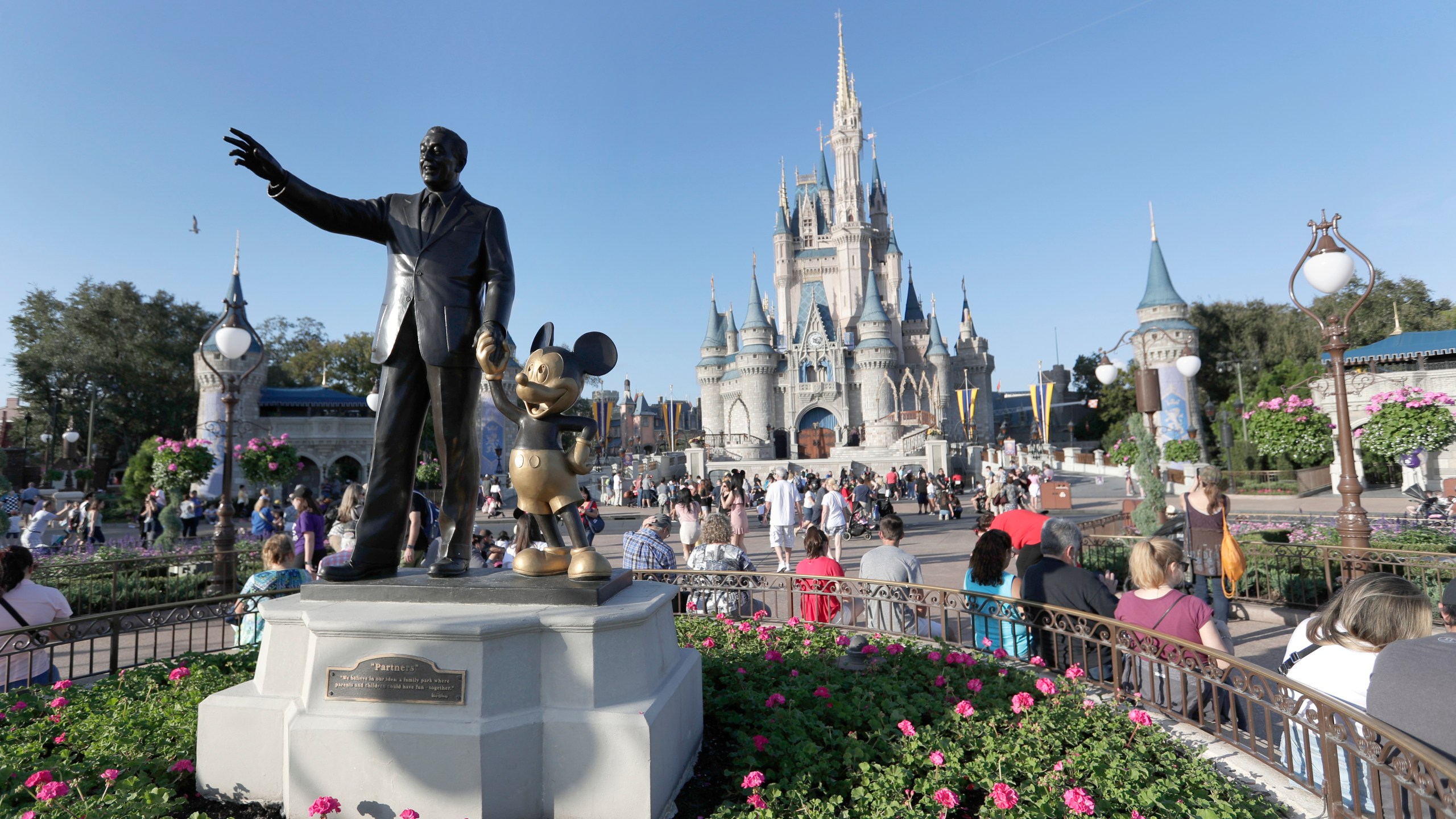 FILE - A statue of Walt Disney and Mickey Mouse appears in front of the Cinderella Castle at the Magic Kingdom theme park at Walt Disney World, Jan. 15, 2020, in Lake Buena Vista, Fla. The earliest version of Disney's most famous character, Mickey Mouse, and arguably the most iconic character in American pop culture, will become public domain on Jan. 1, 2024. (AP Photo/John Raoux, File)