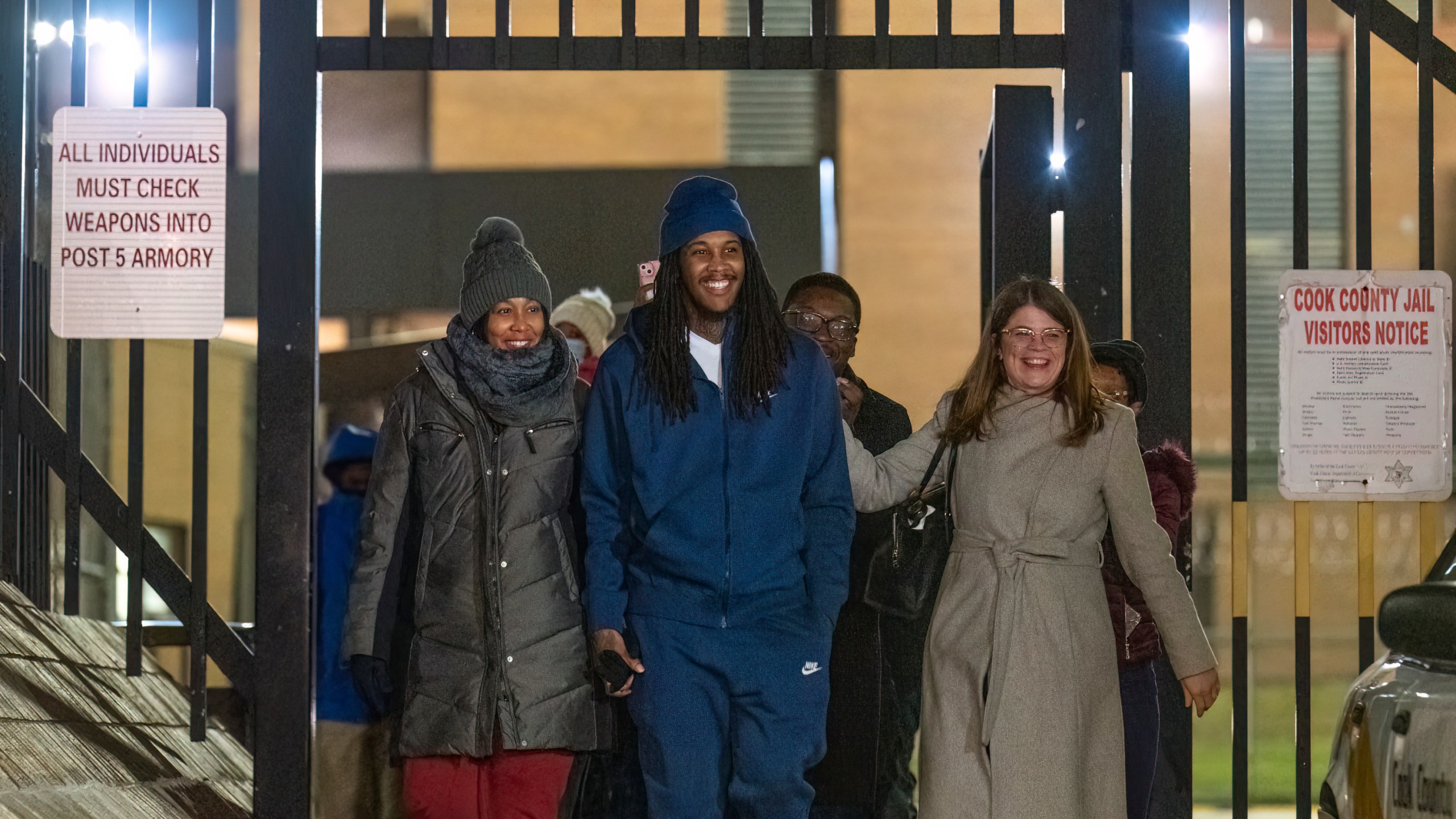 Darien Harris, flanked by his mother Nakesha Harris, left, and his lawyer walk past the gate of Cook County Jail after prosecutors dropped charges on Harris for a fatal shooting in 2011 in a Woodlawn gas station he was convicted for and was serving a 76 year long sentence, Tuesday, Dec. 19, 2023, in Cook County, Ill. (Tyler Pasciak LaRiviere/Chicago Sun-Times via AP)