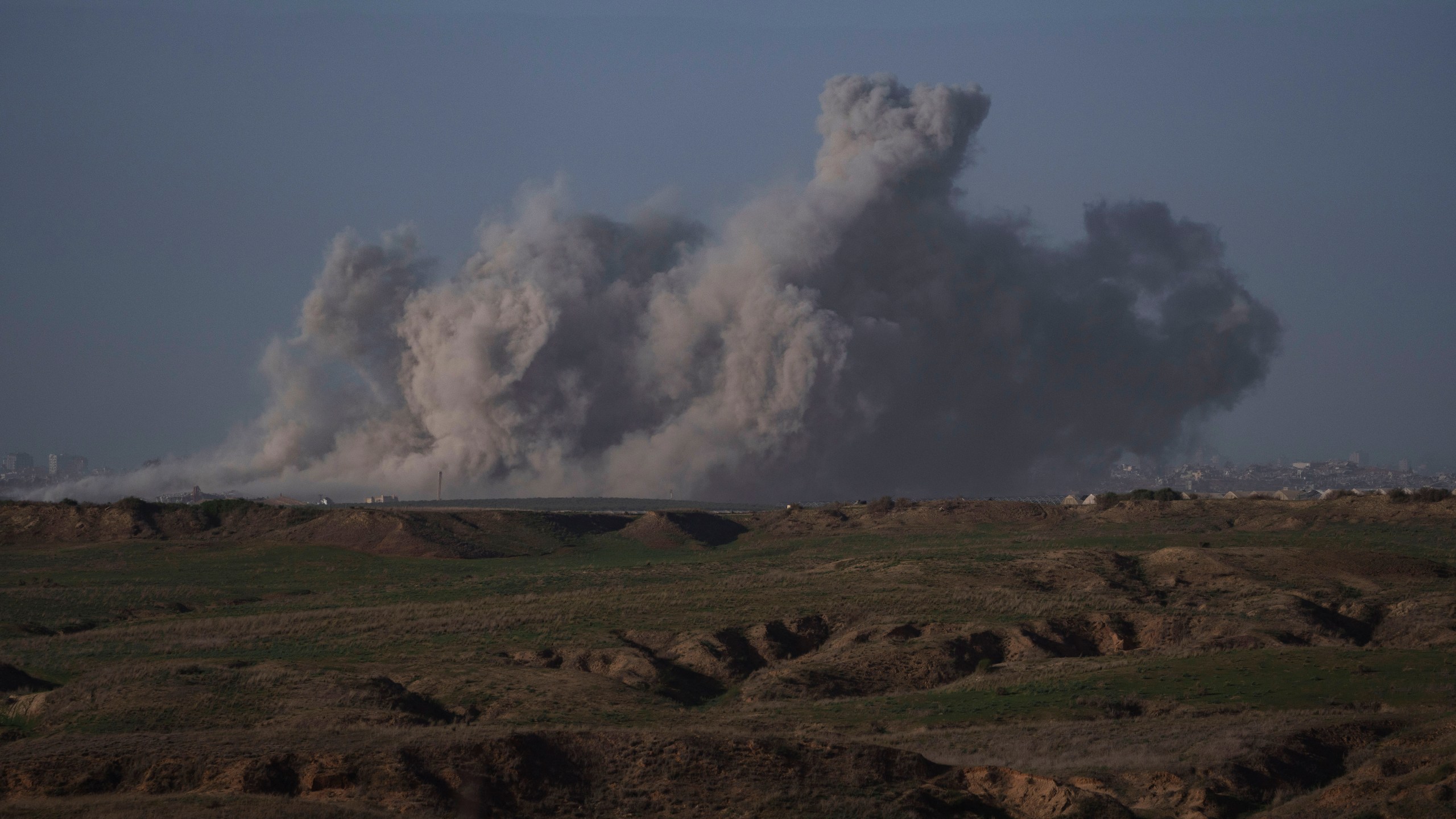 Smoke rises to the sky after an explosion in Gaza Strip as seen from Southern Israel, Friday, Dec. 22, 2023. The Israeli army is battling Palestinian militants across Gaza in the war ignited by Hamas' Oct. 7 attack into Israel. (AP Photo/Leo Correa)