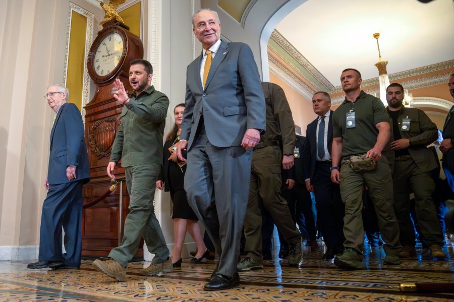 FILE - Ukrainian President Volodymyr Zelenskyy, second from left, walks with Senate Minority Leader Mitch McConnell of Ky., left, and Senate Majority Leader Chuck Schumer of N.Y., right, at Capitol Hill on Thursday, Sept. 21, 2023, in Washington. Congress broke for the holidays, not expected to return for two weeks while continued aid for Ukraine has nearly been exhausted. (AP Photo/Mark Schiefelbein, File)