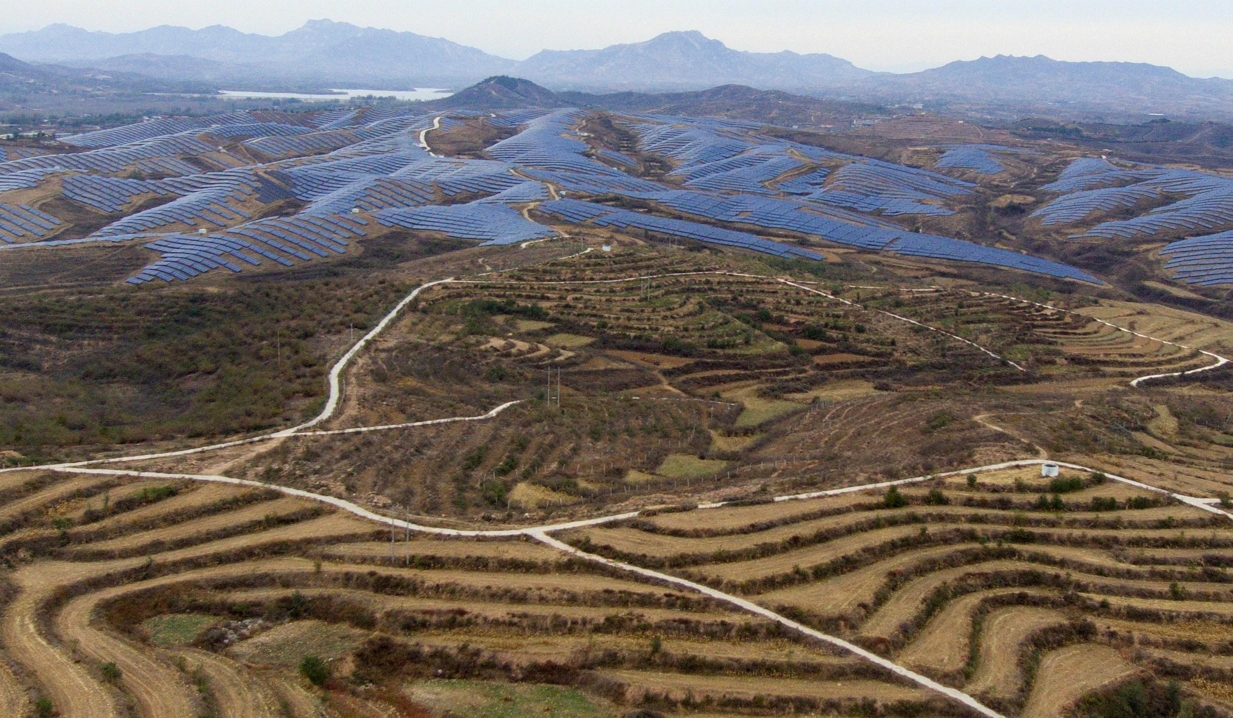 A solar farm operates next to Donggou village in the northern China's Hebei province, Friday, Nov. 10, 2023. Solar is now the cheapest form of electricity in a majority of countries. (AP Photo/Ng Han Guan)