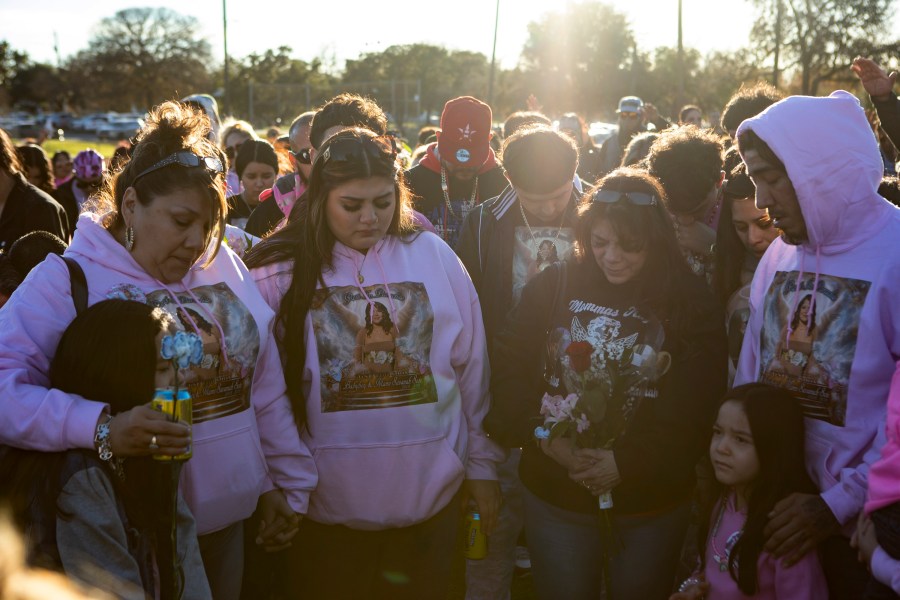 Vigil attendees pray over Savanah's family members (left to right) Serenity Corona, Laura Cordova, Joanie Wasil, Gloria Cordova, Stasia Corona, and Gerald Corona at a vigil for Savanah Soto, 18, and her unborn baby Fabian at Kenwood Park on Thursday, Dec. 28, 2023 in San Antonio, Texas. Authorities say Soto and Guerra were found earlier this week with gunshot wounds in a car and may have been dead for days. (Salgu Wissmath/The San Antonio Express-News via AP)