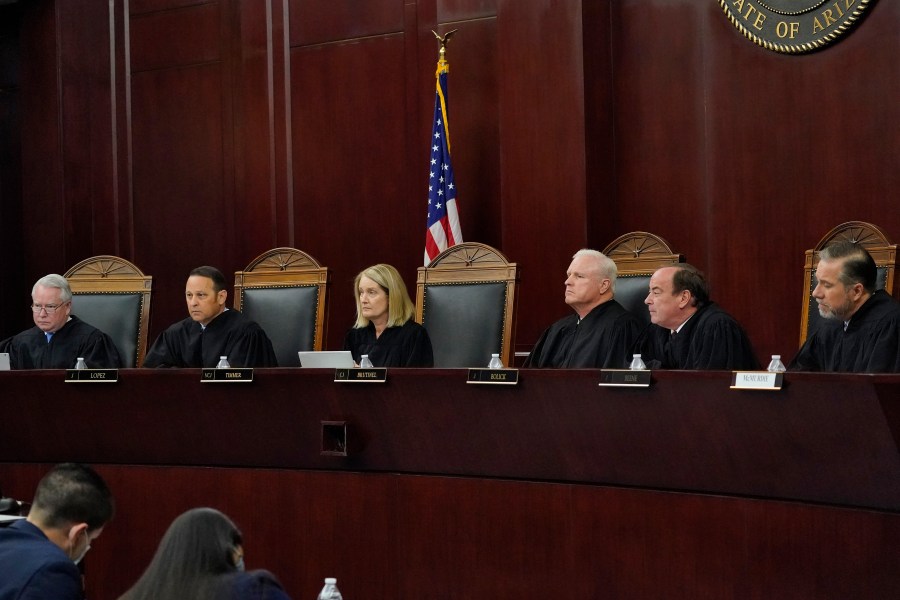 FILE - Arizona Supreme Court Justices from left; William G. Montgomery, John R Lopez IV, Vice Chief Justice Ann A. Scott Timmer, Chief Justice Robert M. Brutinel, Clint Bolick and James Beene listen to oral arguments on April 20, 2021, in Phoenix. (AP Photo/Matt York, File)